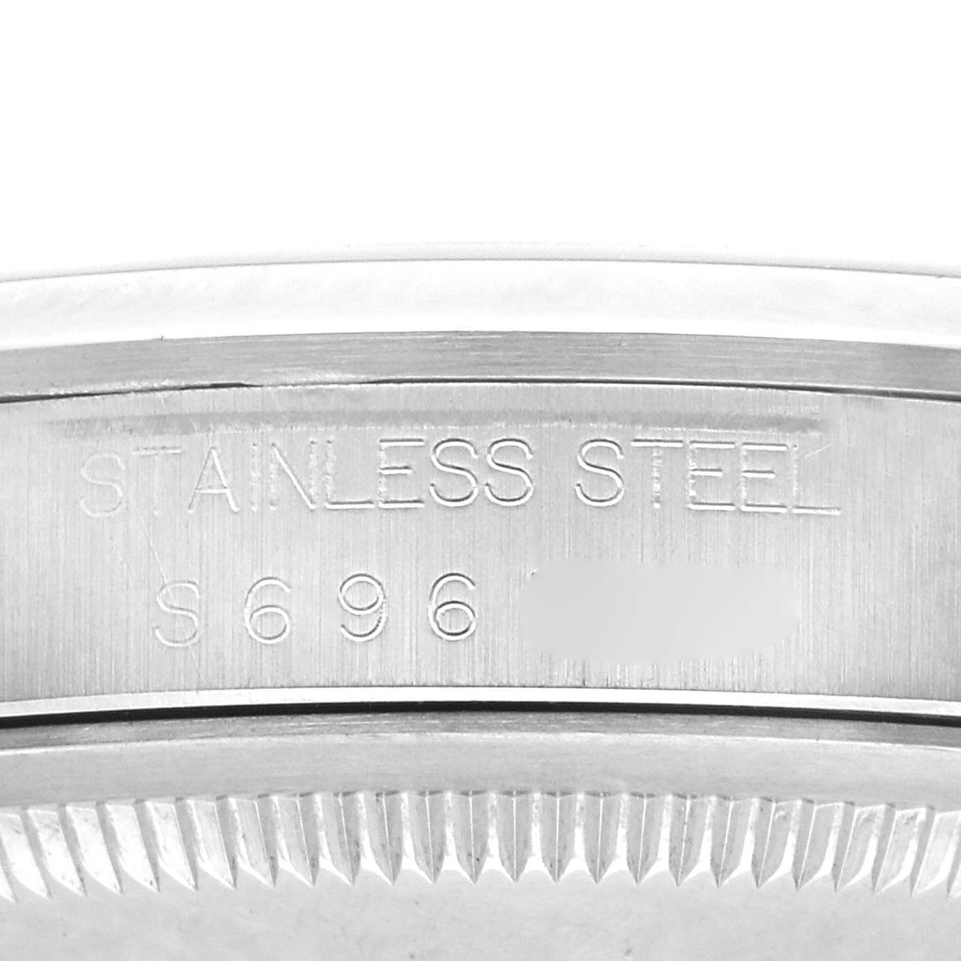 The image shows a close-up of the Rolex Explorer 14270 Men
s Stainless Steel Black Dial 14270 Men
s Stainless Steel Black Dial
s stainless steel case with engraved serial numbers.