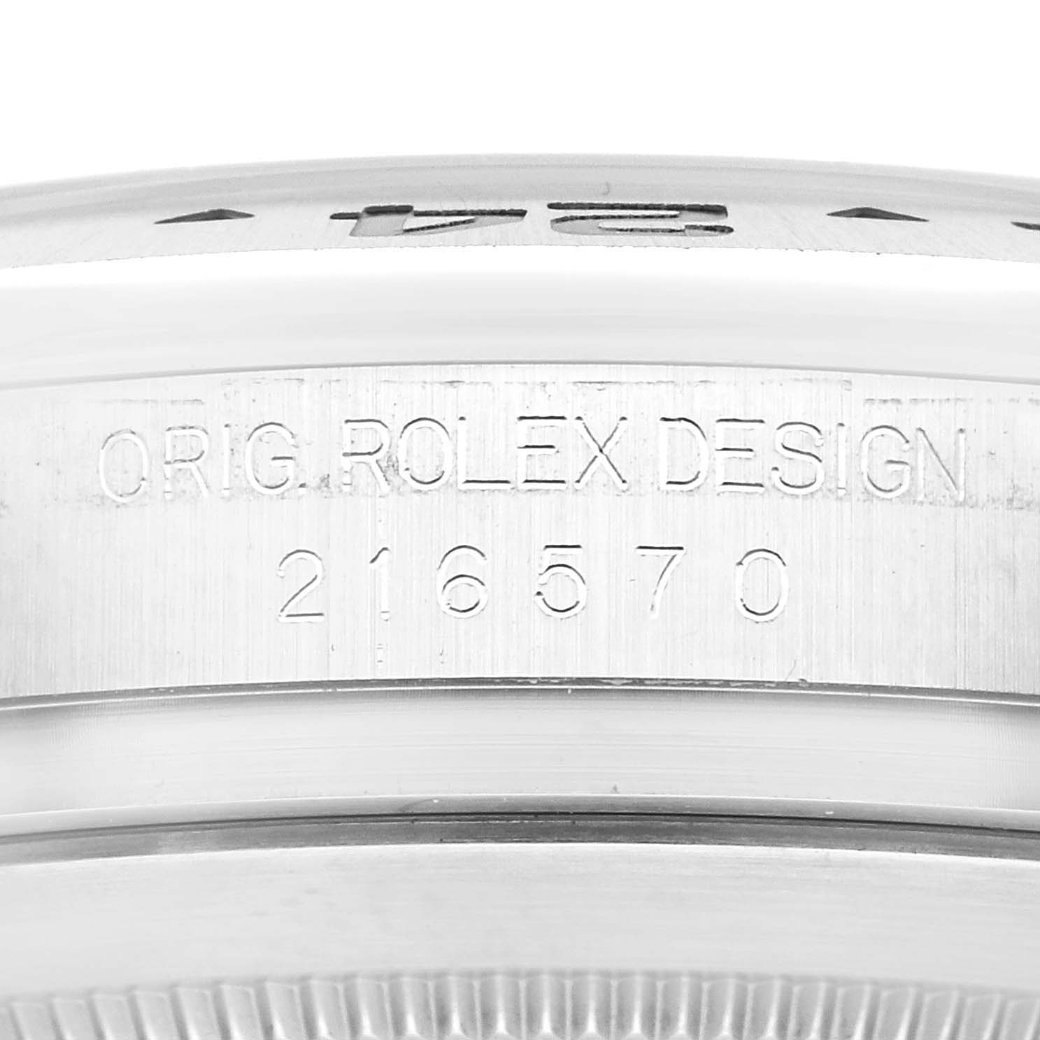 The image shows a close-up of the serial and design engravings on the side of the bezel of a Rolex Explorer 216570 Men
s Stainless Steel White Dial 216570 Men
s Stainless Steel White Dial watch.