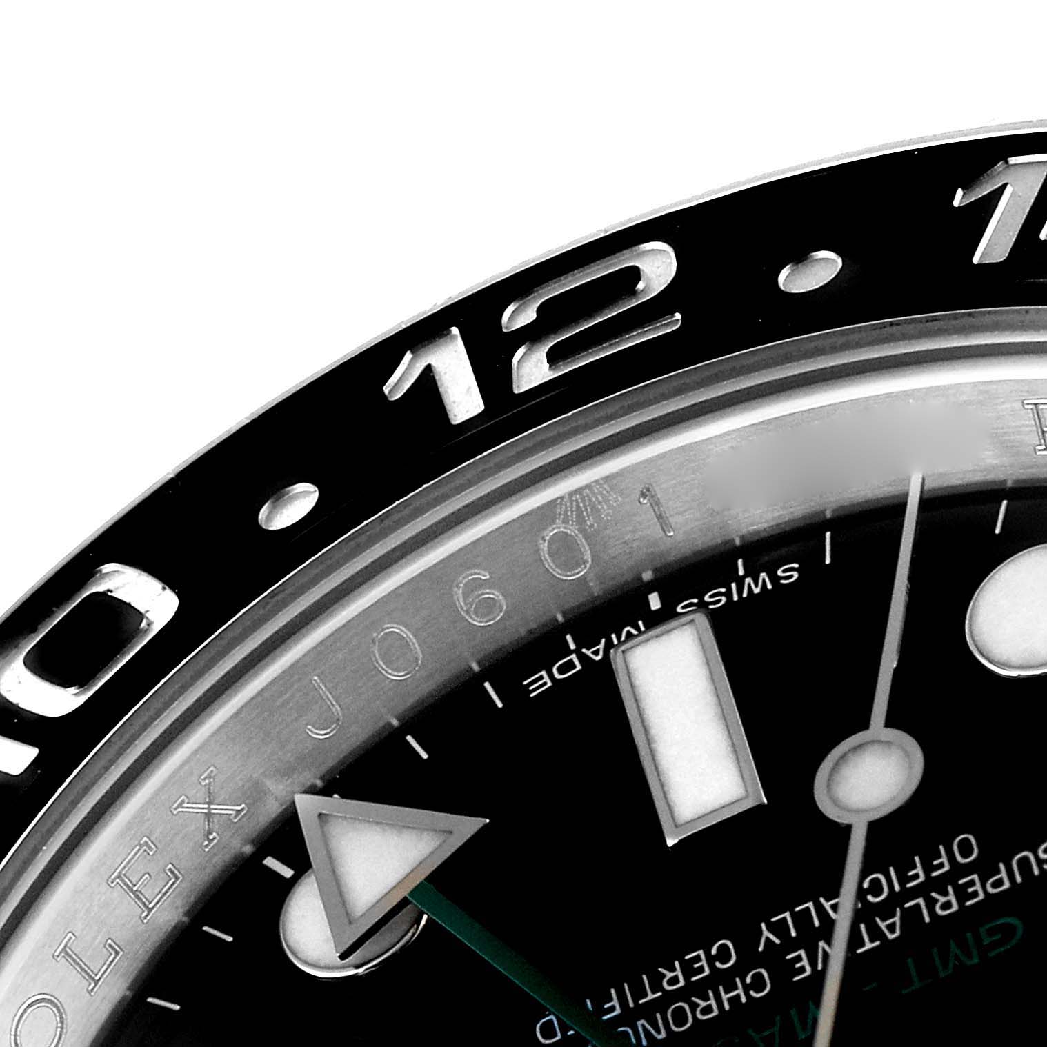 This close-up image shows the upper portion of the dial and bezel of the Rolex GMT-Master 116710 Men
s Stainless Steel Black Dial 116710 Men
s Stainless Steel Black Dial watch, revealing the "12" marker and part of the watch face.