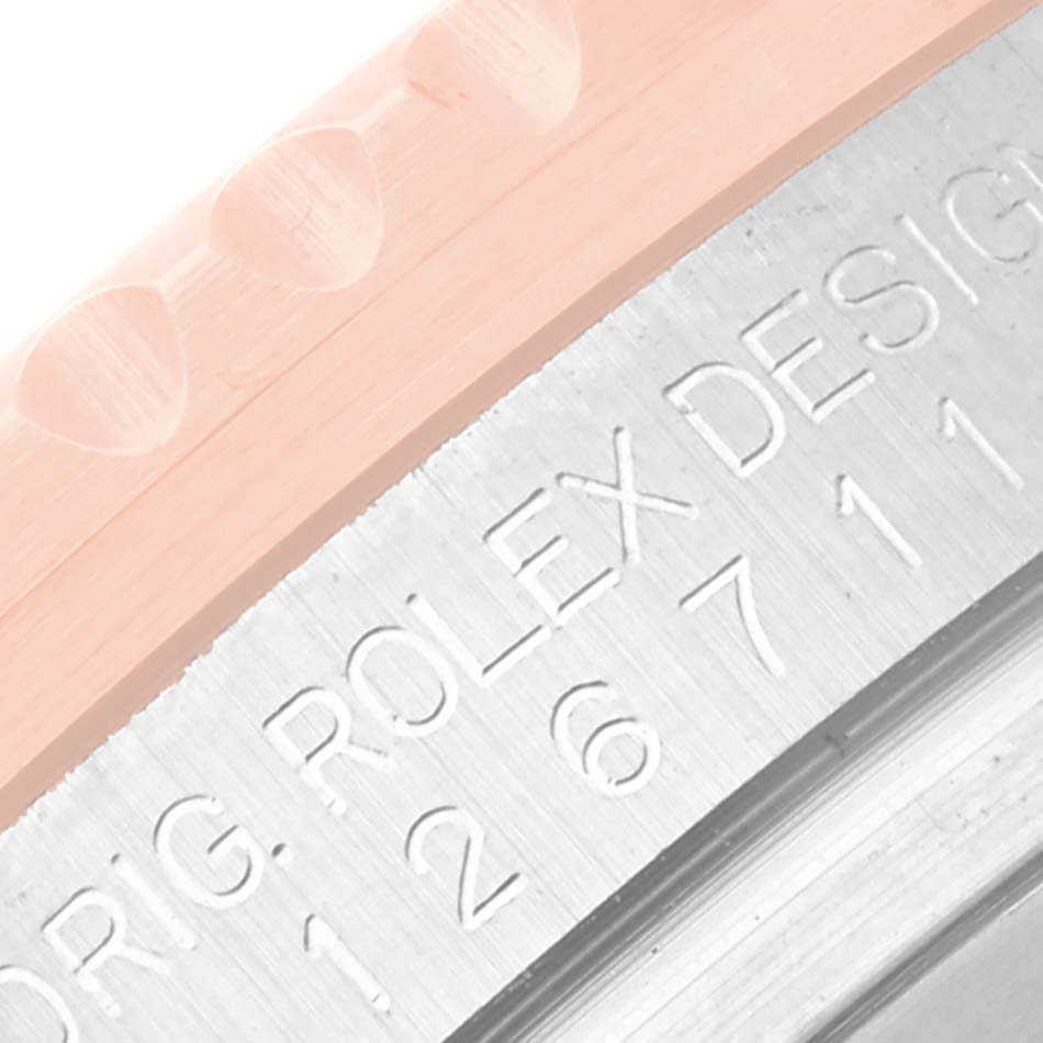 This image shows a close-up of the engraving on the side of the bezel and case of a Rolex GMT-Master 126711CHNR Men's Steel and Gold (two tone) Black Dial 126711CHNR Men's Steel and Gold (two tone) Black Dial watch.