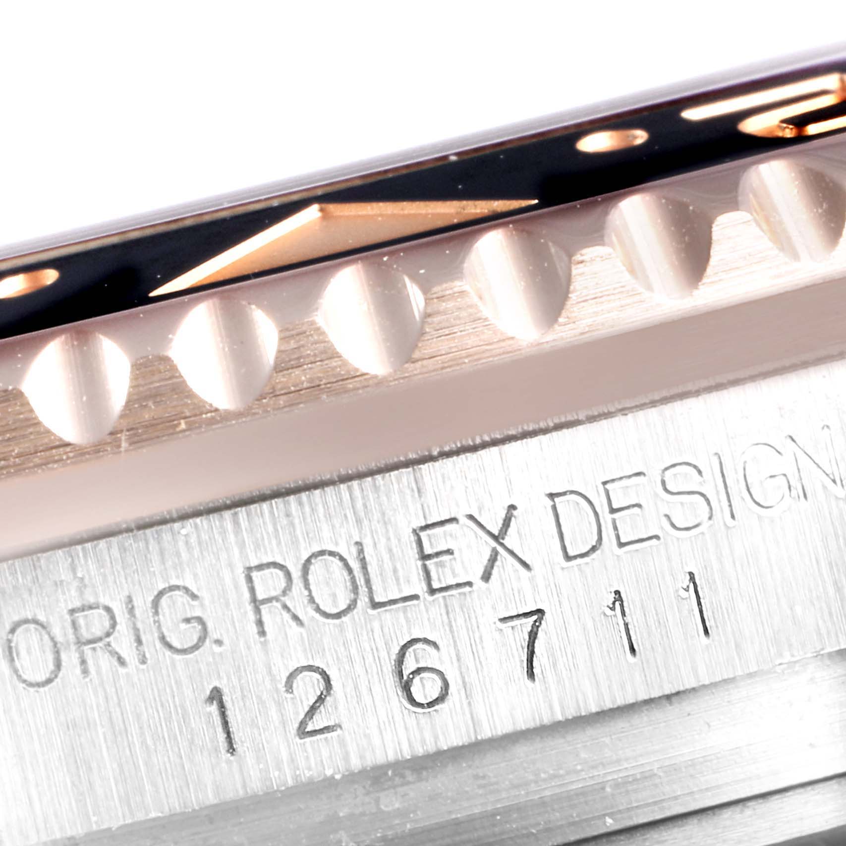 The image shows a close-up of the bezel and case side with the model number engraving on a Rolex GMT-Master 126711 Men
s Steel and Gold (two tone) Black Dial 126711 Men
s Steel and Gold (two tone) Black Dial watch.