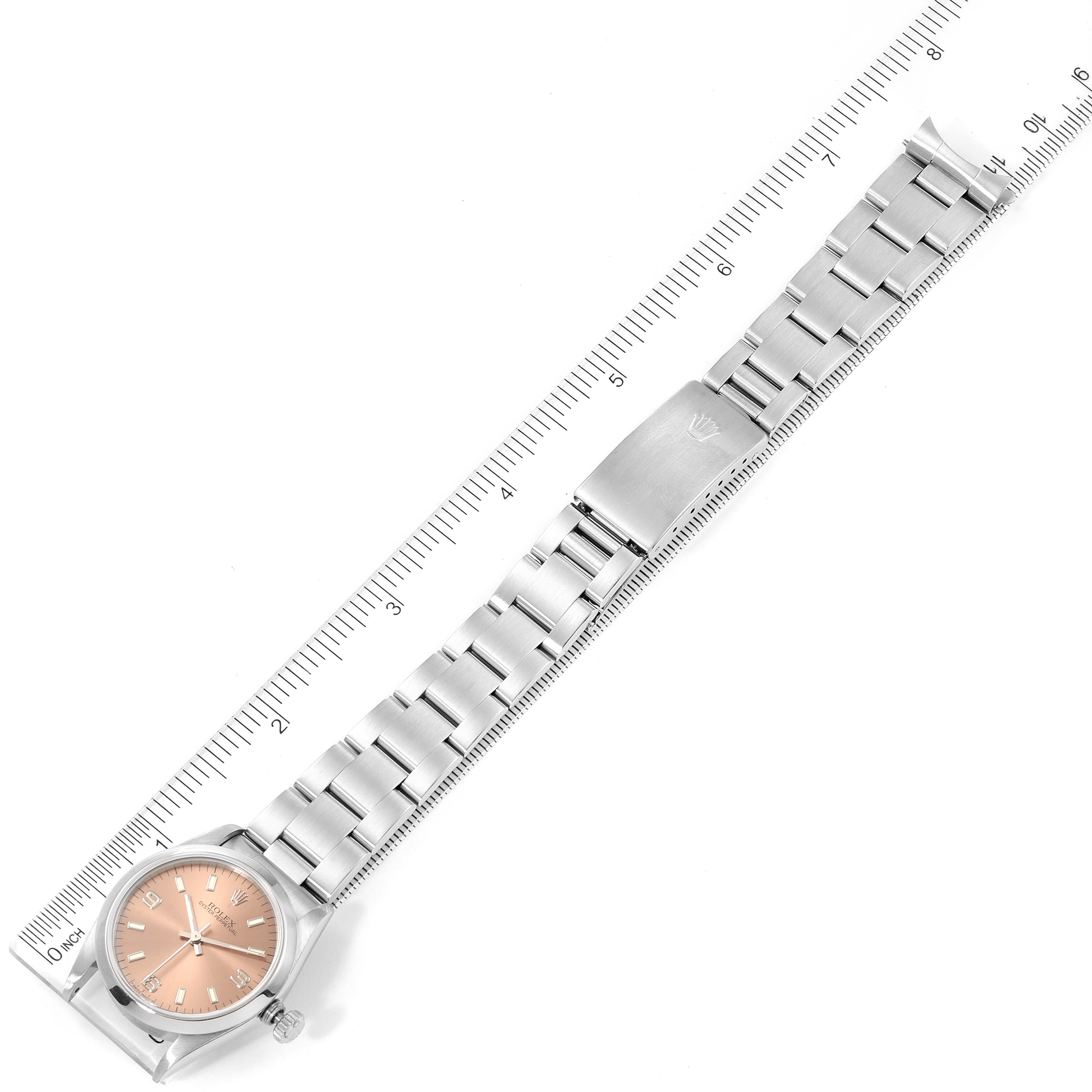 The image shows a top-down view of the Mid-Size Rolex watch with its entire band and clasp extended alongside a ruler.