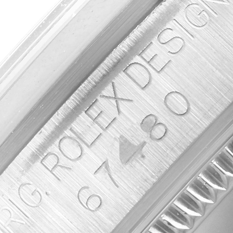 The image shows a close-up of the serial number engraving on the case side of a Rolex Mid-Size 67480 Women's Stainless Steel Pink Dial 67480 Women's Stainless Steel Pink Dial watch.