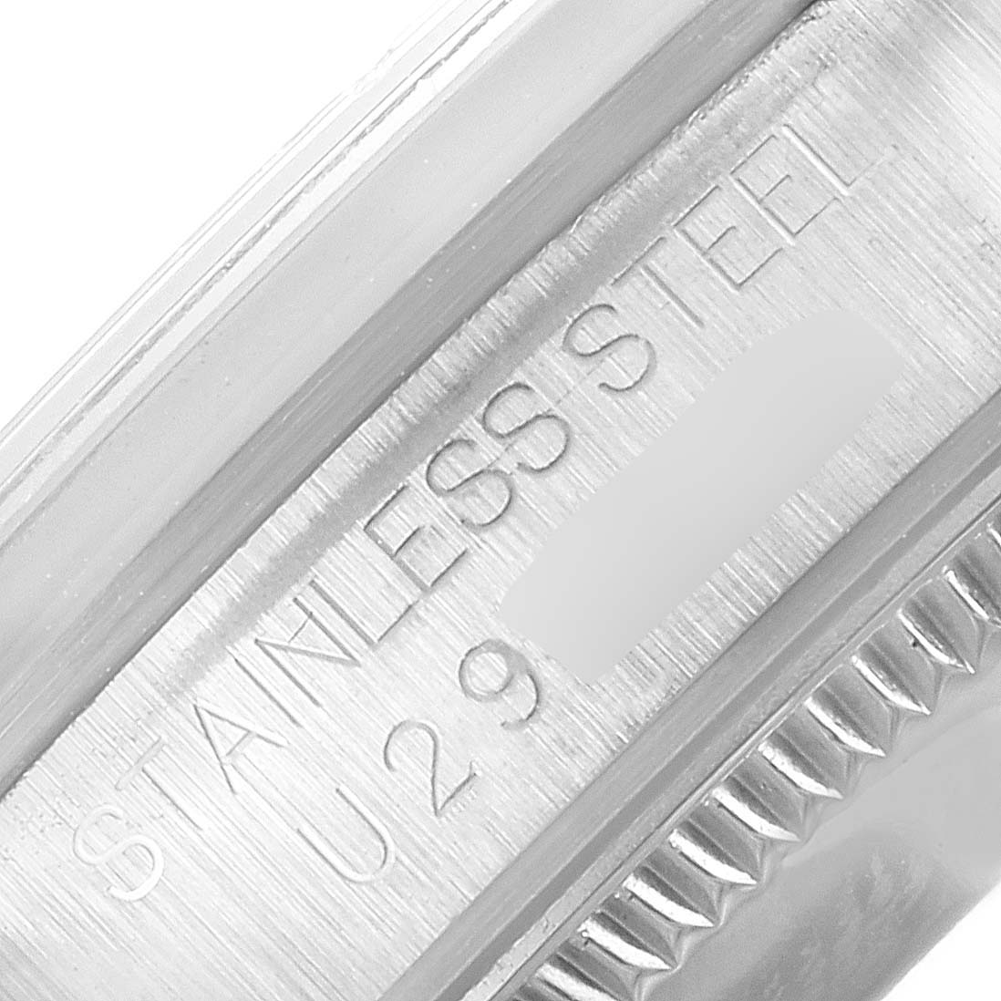 This image shows a close-up of the stainless steel engraving on a Rolex Mid-Size 67480 Women's Stainless Steel Pink Dial 67480 Women's Stainless Steel Pink Dial model.