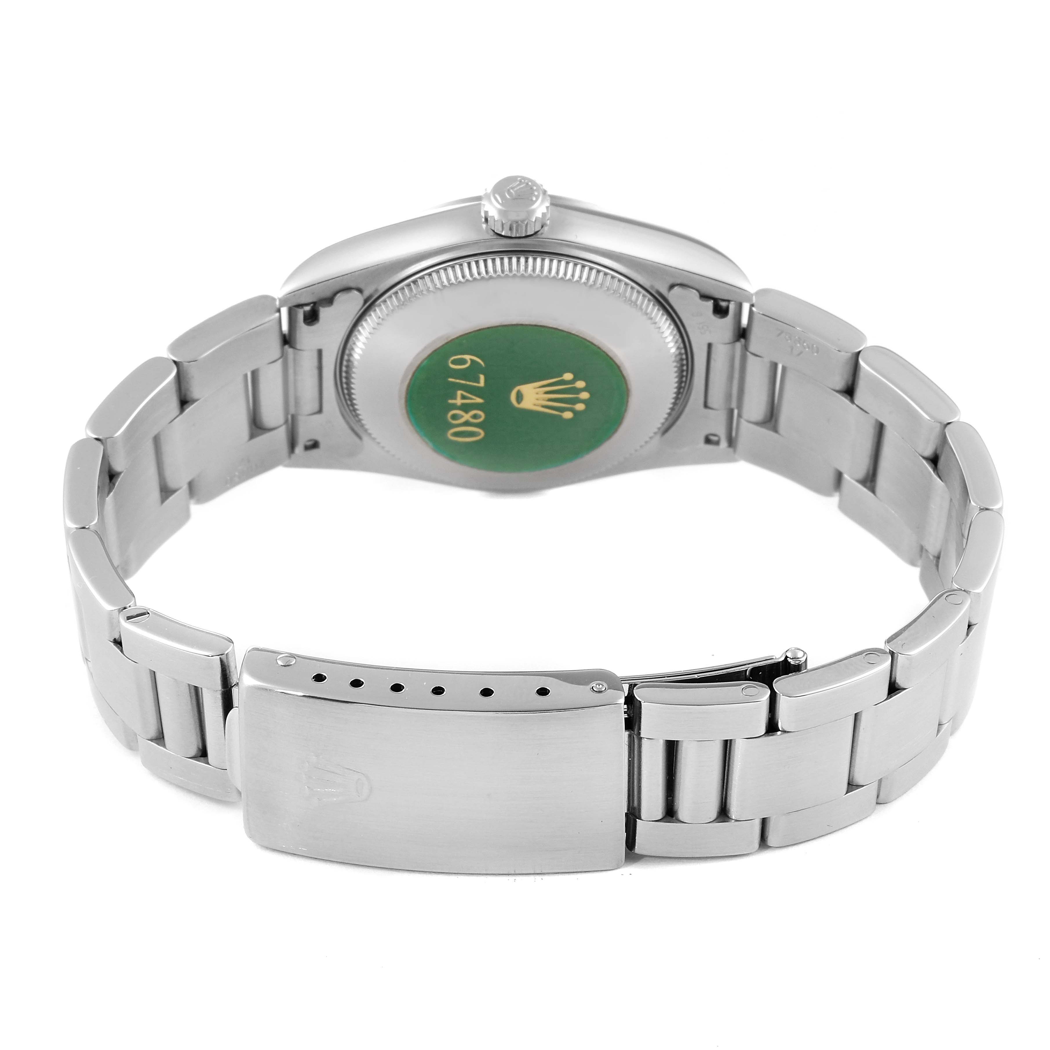 The image shows the back of the Rolex Mid-Size 67480 Women
s Stainless Steel Black Dial 67480 Women
s Stainless Steel Black Dial watch, displaying its bracelet, clasp, and case back.