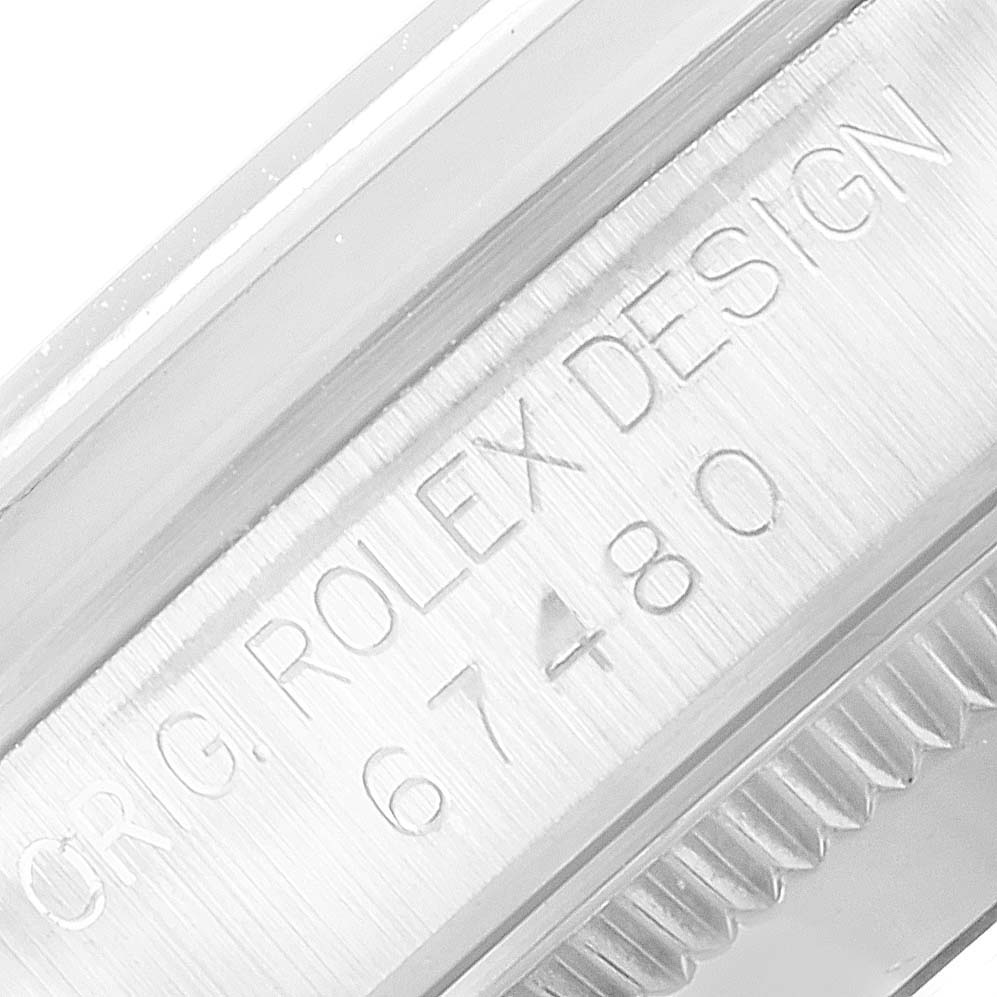 This close-up image of the Mid-Size Rolex watch shows the engraved model number "67480" and "ORIG. ROLEX DESIGN" on the case.