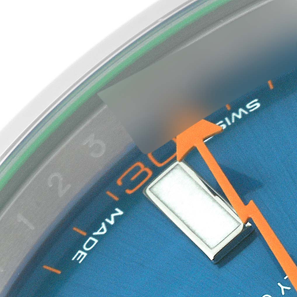 The image shows a close-up of the dial on the Rolex Milgauss 116400GV Men
s Stainless Steel Blue Dial 116400GV Men
s Stainless Steel Blue Dial watch, highlighting the hour marker, orange hand, and minute track.