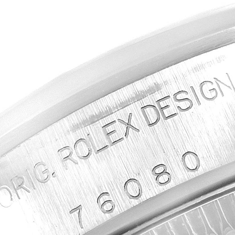This close-up image shows part of the case back with engravings on a Rolex Oyster Perpetual 76080 Women
s Stainless Steel Blue Dial 76080 Women
s Stainless Steel Blue Dial watch.