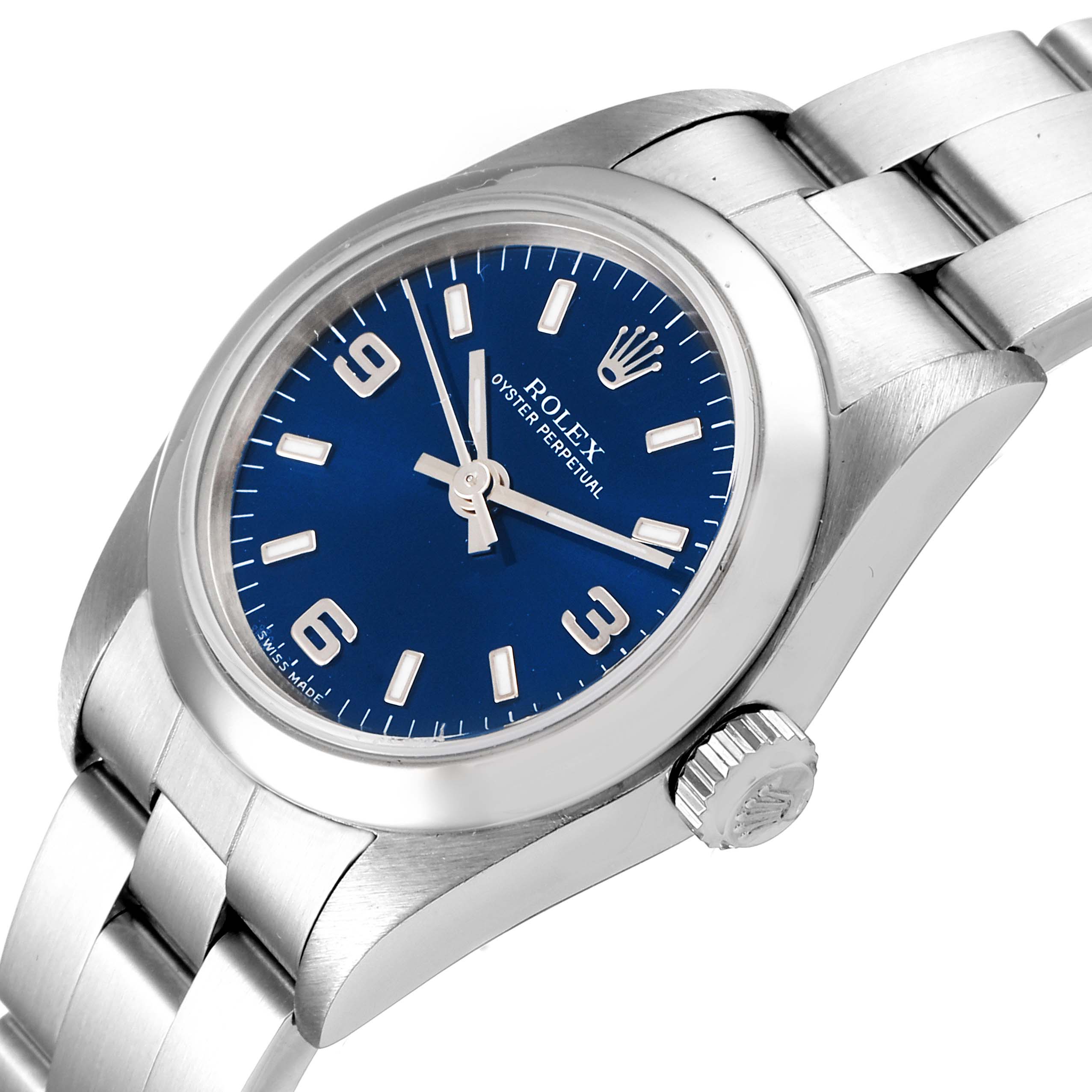 The image shows a top-left angled view of the Rolex Oyster Perpetual 76080 Women
s Stainless Steel Blue Dial 76080 Women
s Stainless Steel Blue Dial, highlighting its blue dial, bezel, crown, and stainless steel bracelet.