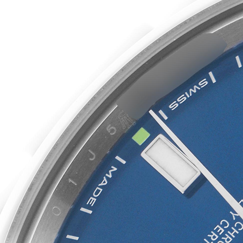 The image shows a close-up of a blue dial, sapphire crystal edge, and part of the bezel of a Rolex Oyster Perpetual 114300 Men's Stainless Steel Blue Dial 114300 Men's Stainless Steel Blue Dial watch.