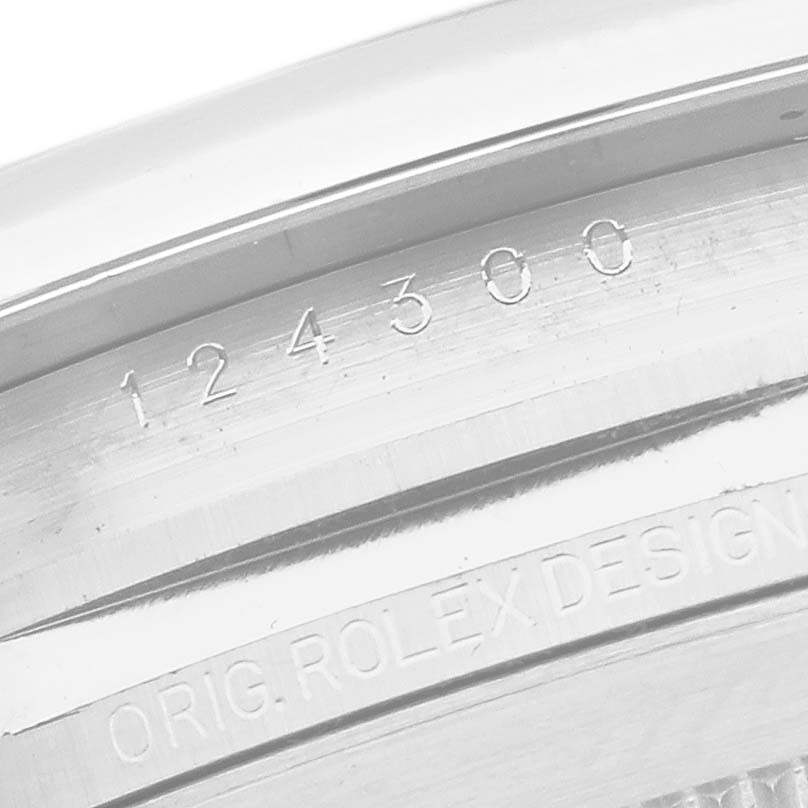 The image shows the engraved side detail of a Rolex Oyster Perpetual 124300 Men
s Stainless Steel Silver Dial 124300 Men
s Stainless Steel Silver Dial watch case, displaying the model number and design inscription.