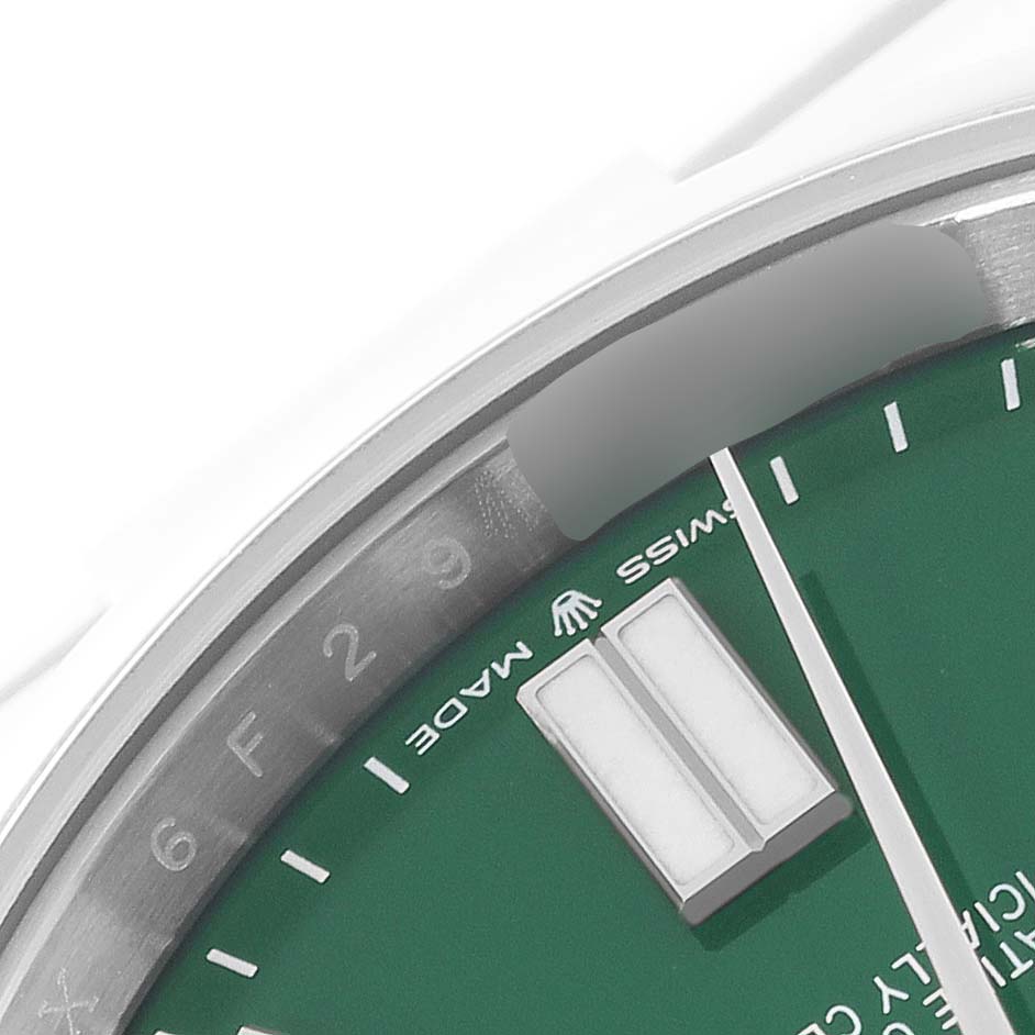 The image shows a close-up of the dial and chapter ring of a Rolex Oyster Perpetual 124300 Men's Stainless Steel Green Dial 124300 Men's Stainless Steel Green Dial watch.