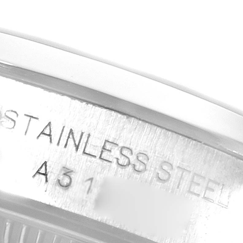 This image shows a close-up of the case back of a Rolex Oyster Perpetual 76080 Women
s Stainless Steel Silver Dial 76080 Women
s Stainless Steel Silver Dial, highlighting the "STAINLESS STEEL" engraving.