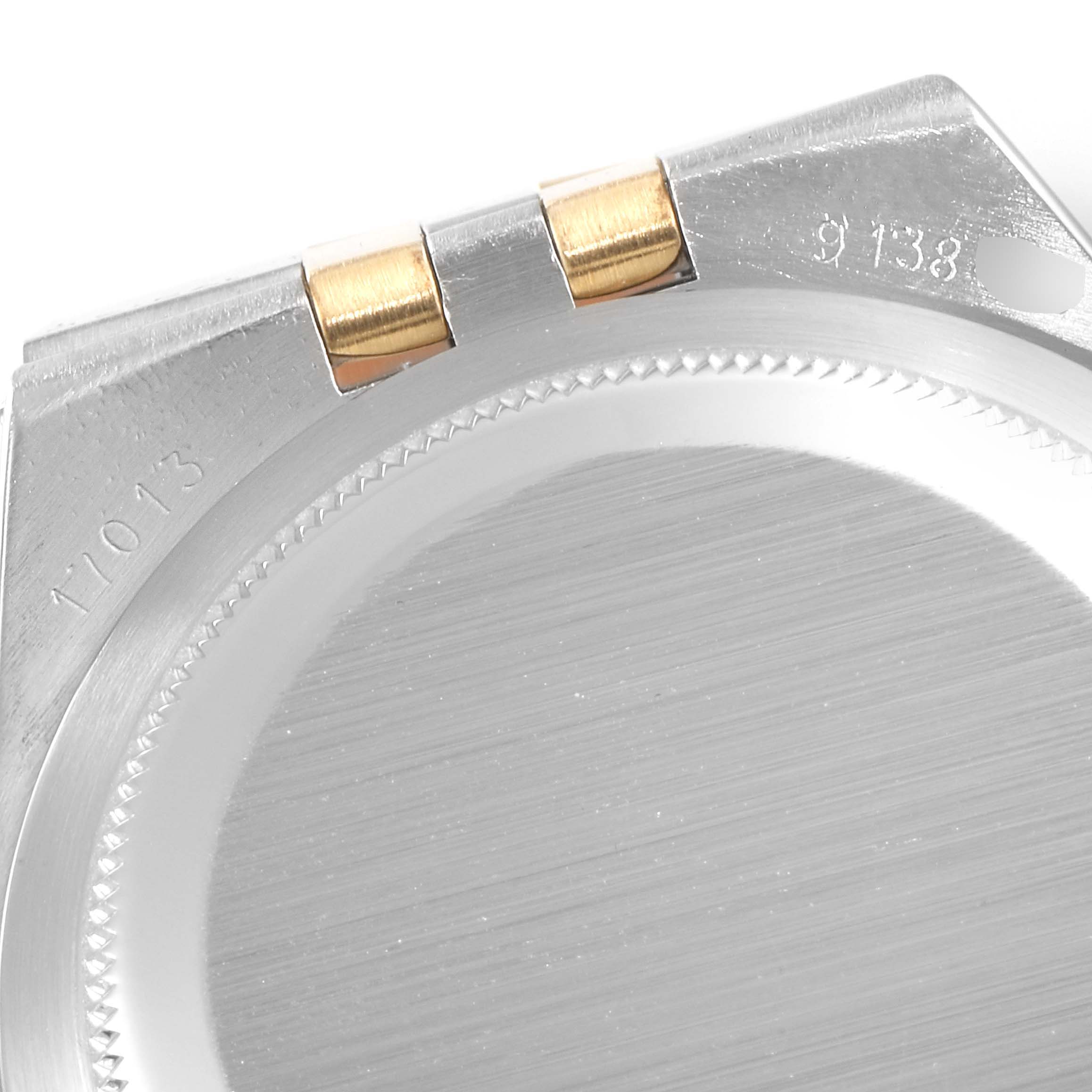 This image shows the case back of a Rolex Oysterquartz 17013 Men's Steel and Gold (two tone) Champagne Dial 17013 Men's Steel and Gold (two tone) Champagne Dial watch, highlighting its brushed metal finish and engraved model numbers.