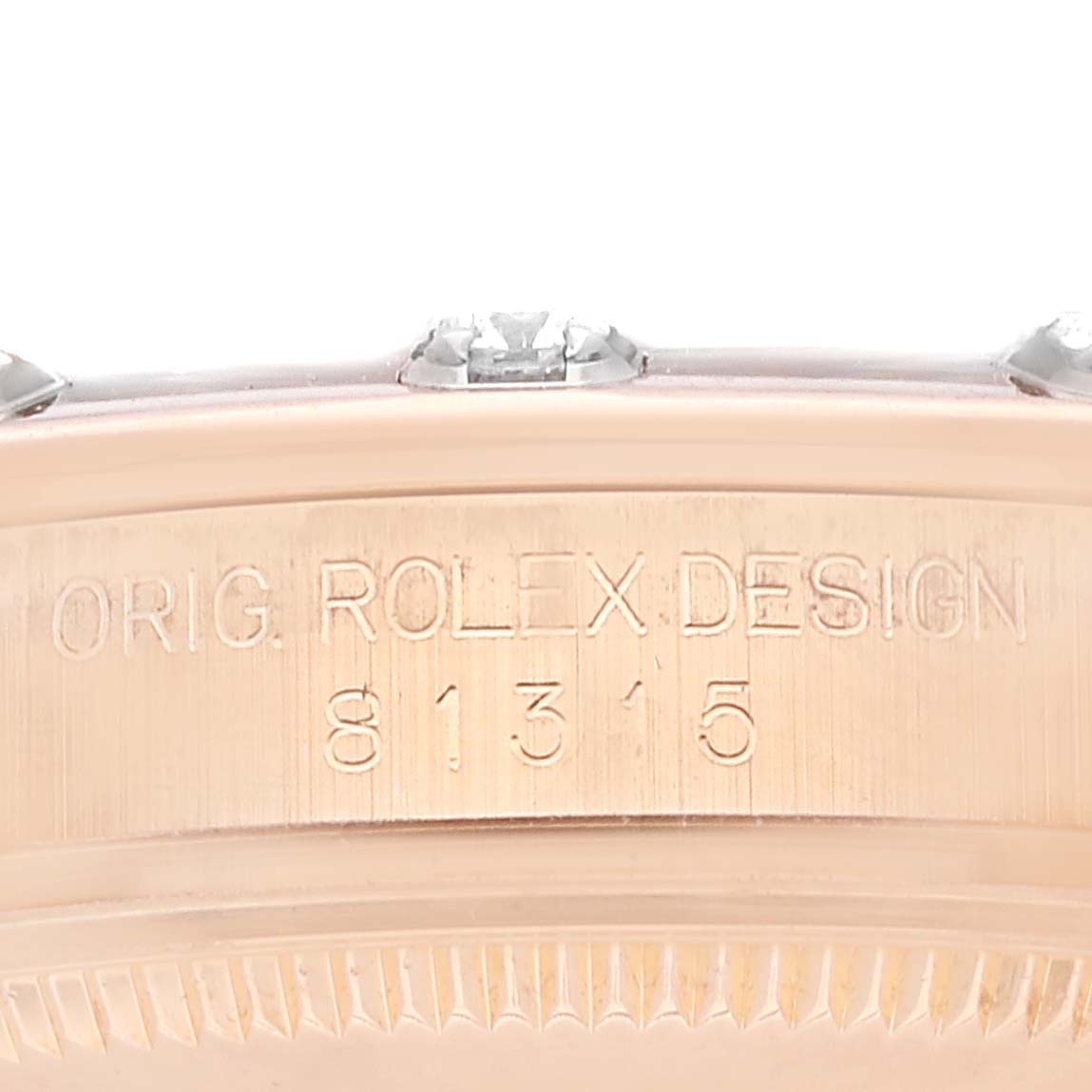 The image shows a close-up of the side of a Rolex Pearlmaster 81315 Women's Rose Gold Brown Dial 81315 Women's Rose Gold Brown Dial watch, featuring its design and model number engraving.