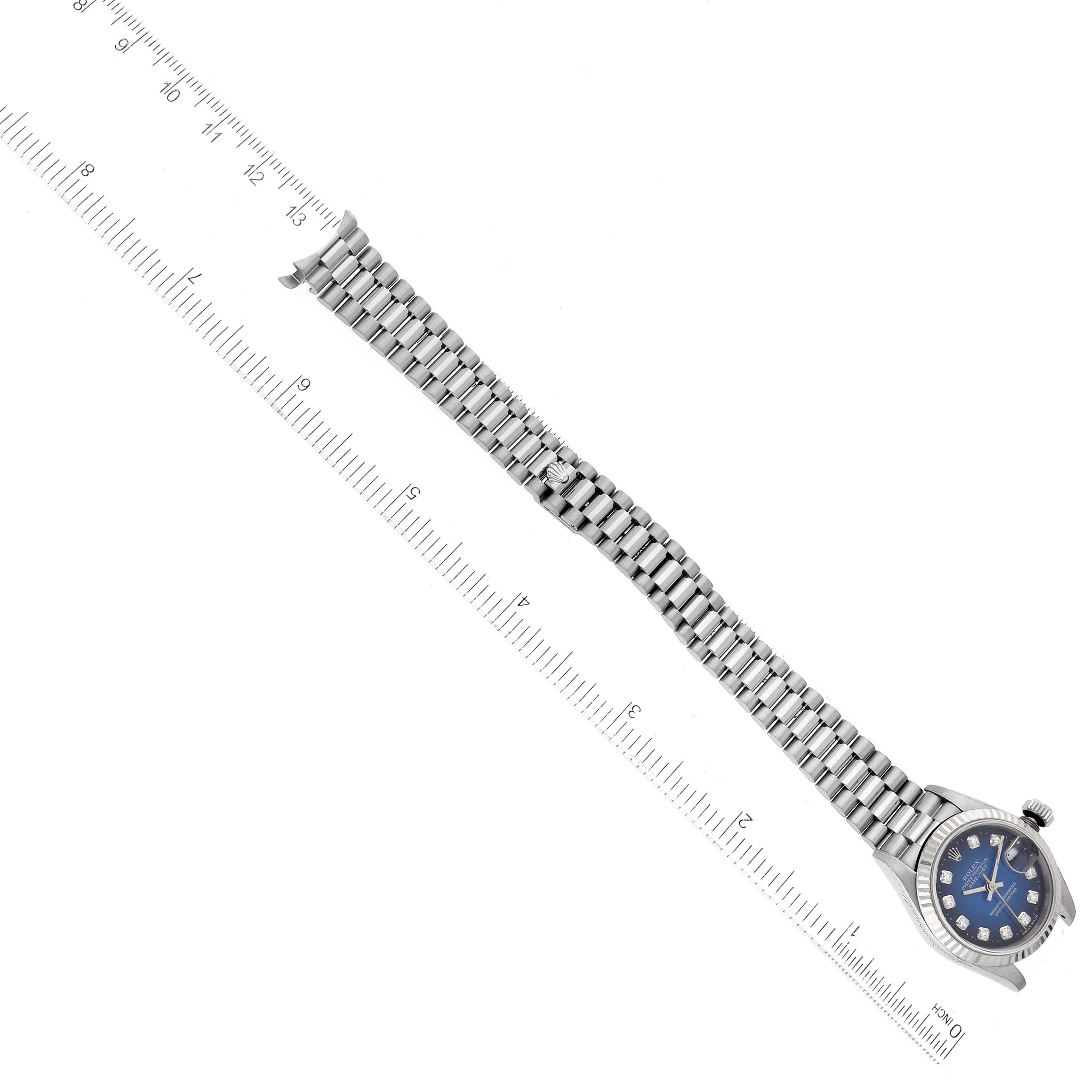 The Rolex President 69179G Women's White Gold Blue Dial 69179G Women's White Gold Blue Dial model watch is shown at an angle, featuring the face, bezel, and full metal bracelet.
