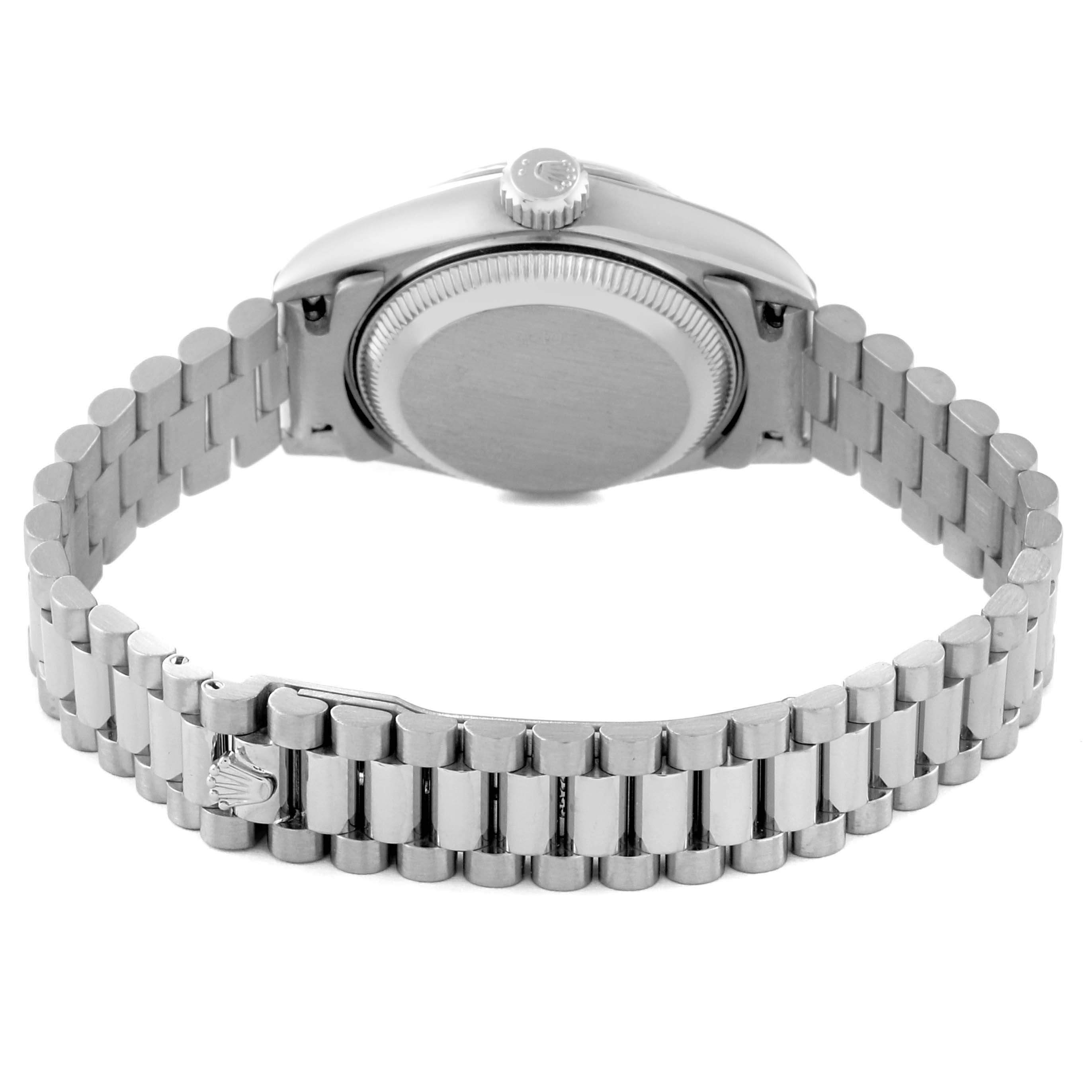 This image shows the back angle of a Rolex President 69179G Women's White Gold Blue Dial 69179G Women's White Gold Blue Dial model watch, featuring its case, crown, and bracelet.