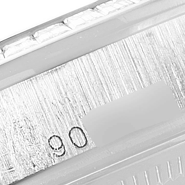 The image shows a macro view of the bezel and part of the bracelet of a Rolex President 118399BR Men's White Gold Silver Dial 118399BR Men's White Gold Silver Dial model watch.