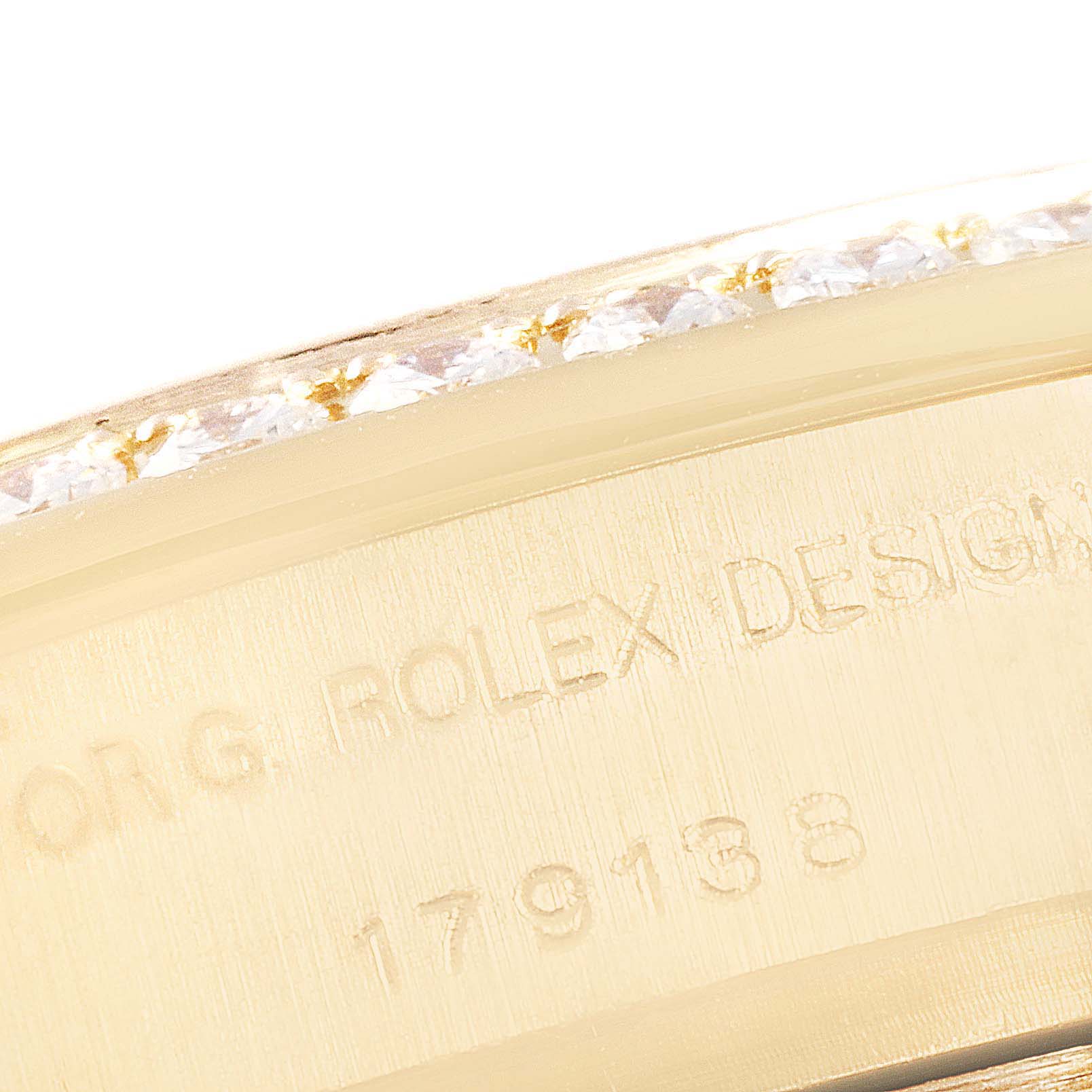 This image shows a close-up of the engraved side of a Rolex President 179138 Women
s Yellow Gold Mother of Pearl Dial 179138 Women
s Yellow Gold Mother of Pearl Dial model watch, including its diamond-studded bezel.