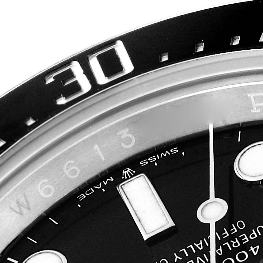 This close-up image of the Rolex Sea-Dweller 126600 Men
s Stainless Steel Black Dial 126600 Men
s Stainless Steel Black Dial watch shows the bezel and part of the dial.