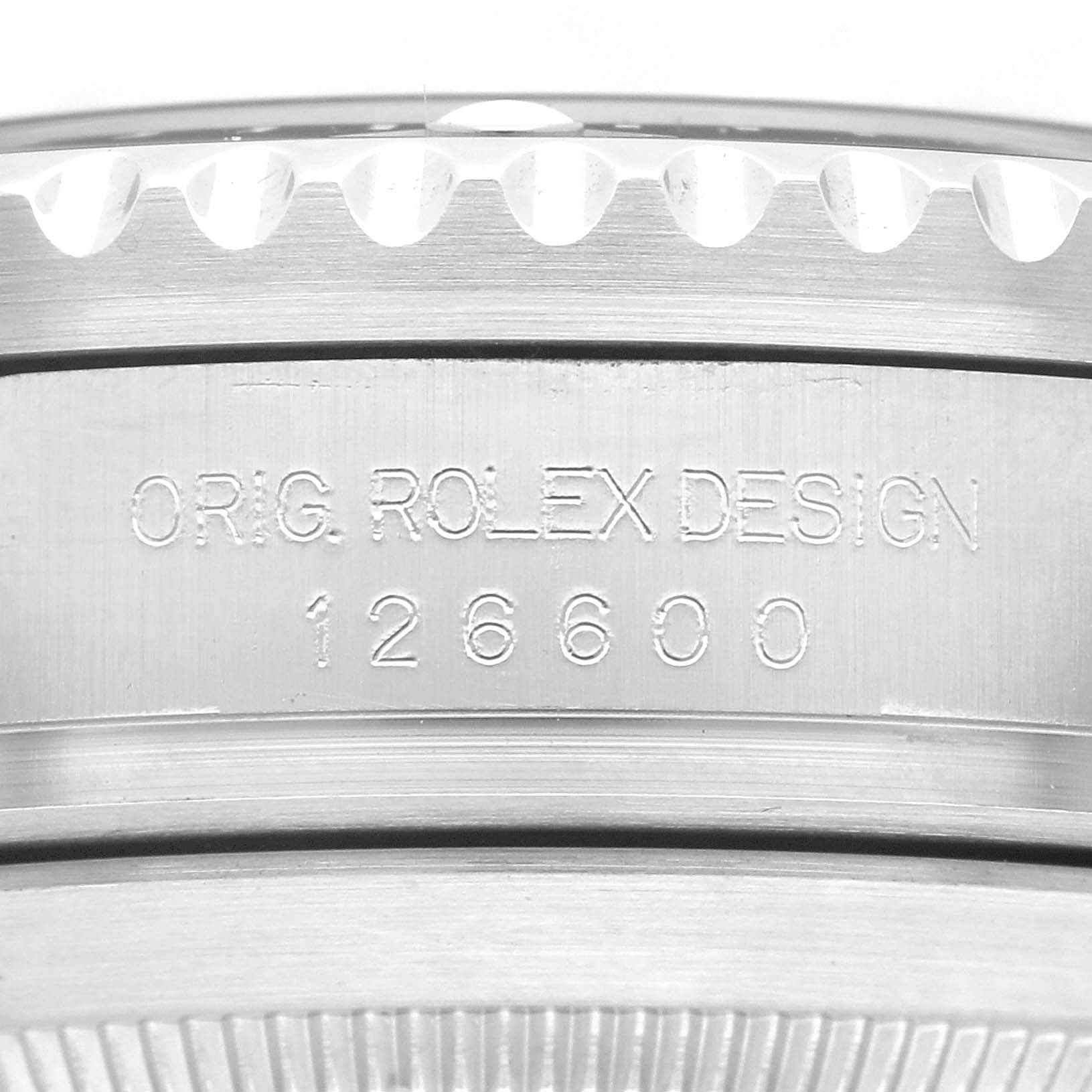 This image shows a close-up of the engraved case side of a Rolex Sea-Dweller 126600 Men
s Stainless Steel Black Dial 126600 Men
s Stainless Steel Black Dial model, displaying the "ORIG. ROLEX DESIGN" and model number 126600.