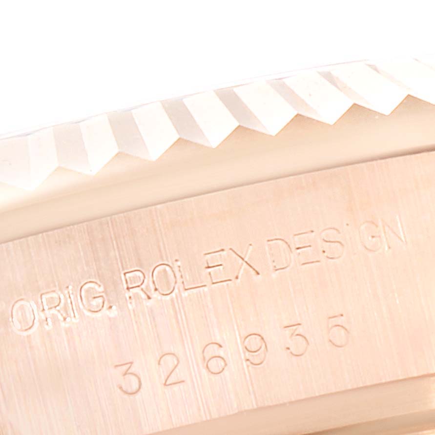 The image shows a close-up of the fluted bezel and case side with engravings of the Rolex Sky-Dweller 326935 Men's Rose Gold White Dial 326935 Men's Rose Gold White Dial watch.