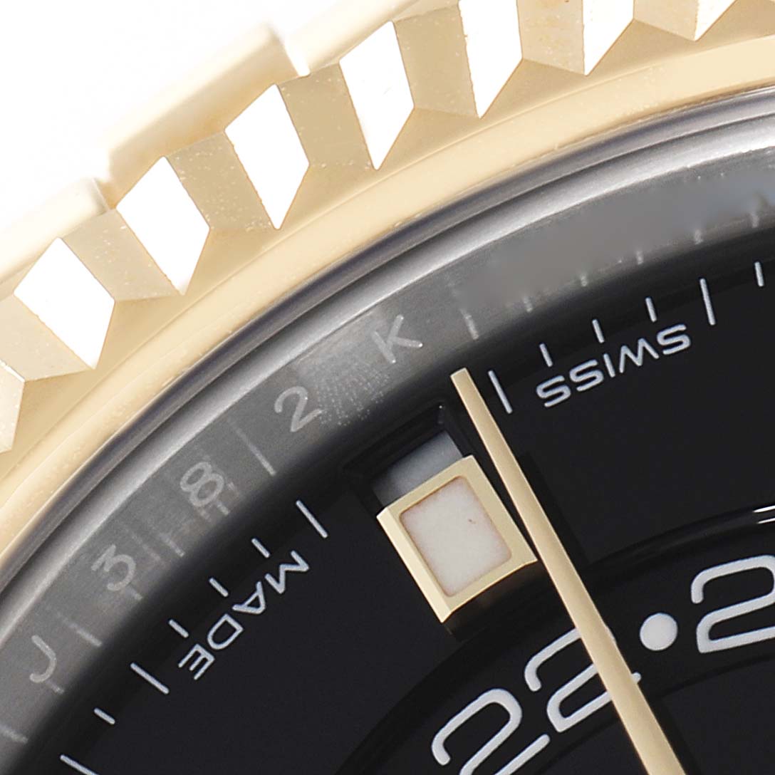 Close-up of the Rolex Sky-Dweller 326933 Men's Steel and Gold (two tone) Black Dial 326933 Men's Steel and Gold (two tone) Black Dial showing the dial, part of the bezel, and the hour marker.