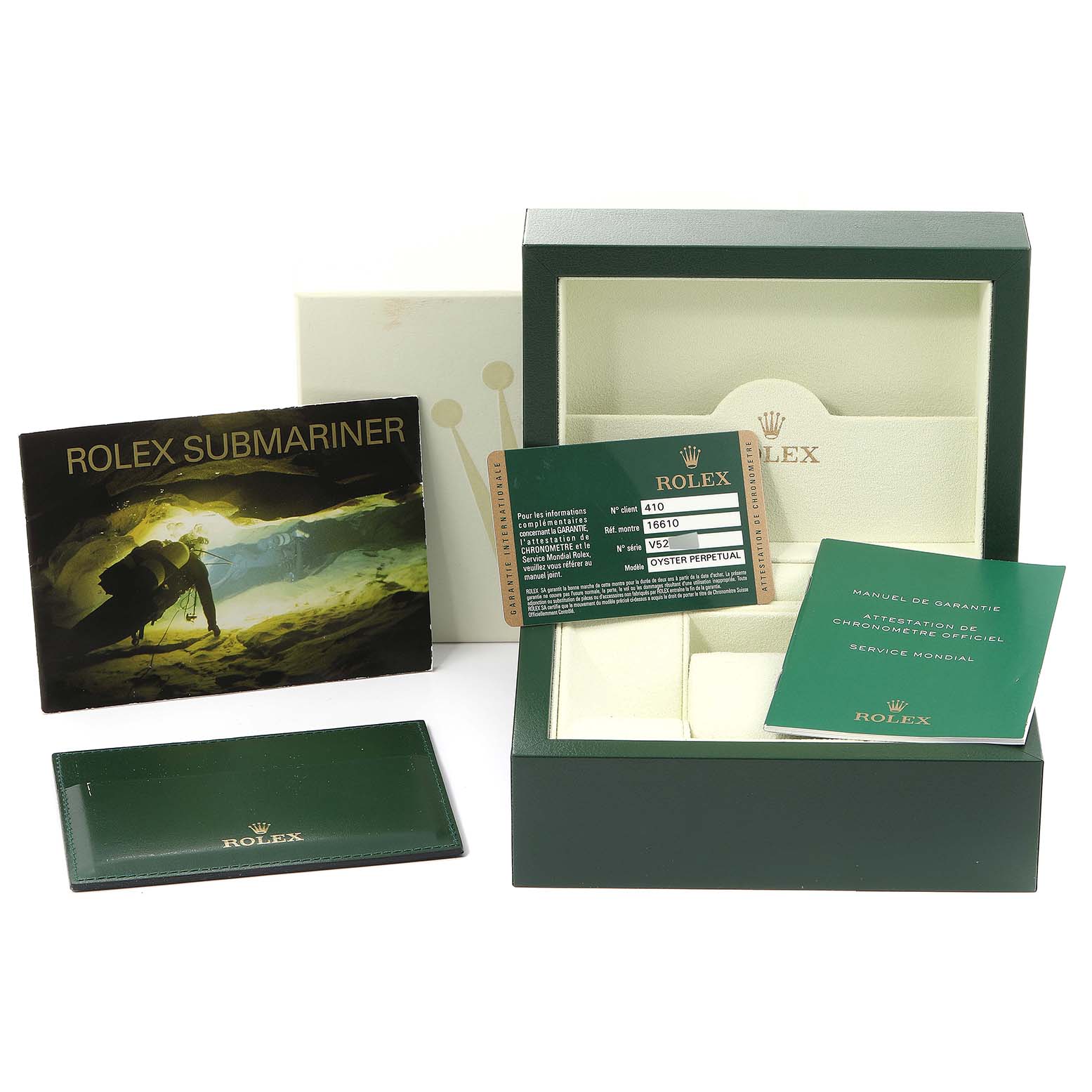 This image shows the packaging and accessories for a Rolex Submariner 16610 Men
s Stainless Steel Black Dial 16610 Men
s Stainless Steel Black Dial, including manuals, cards, and the watch box.