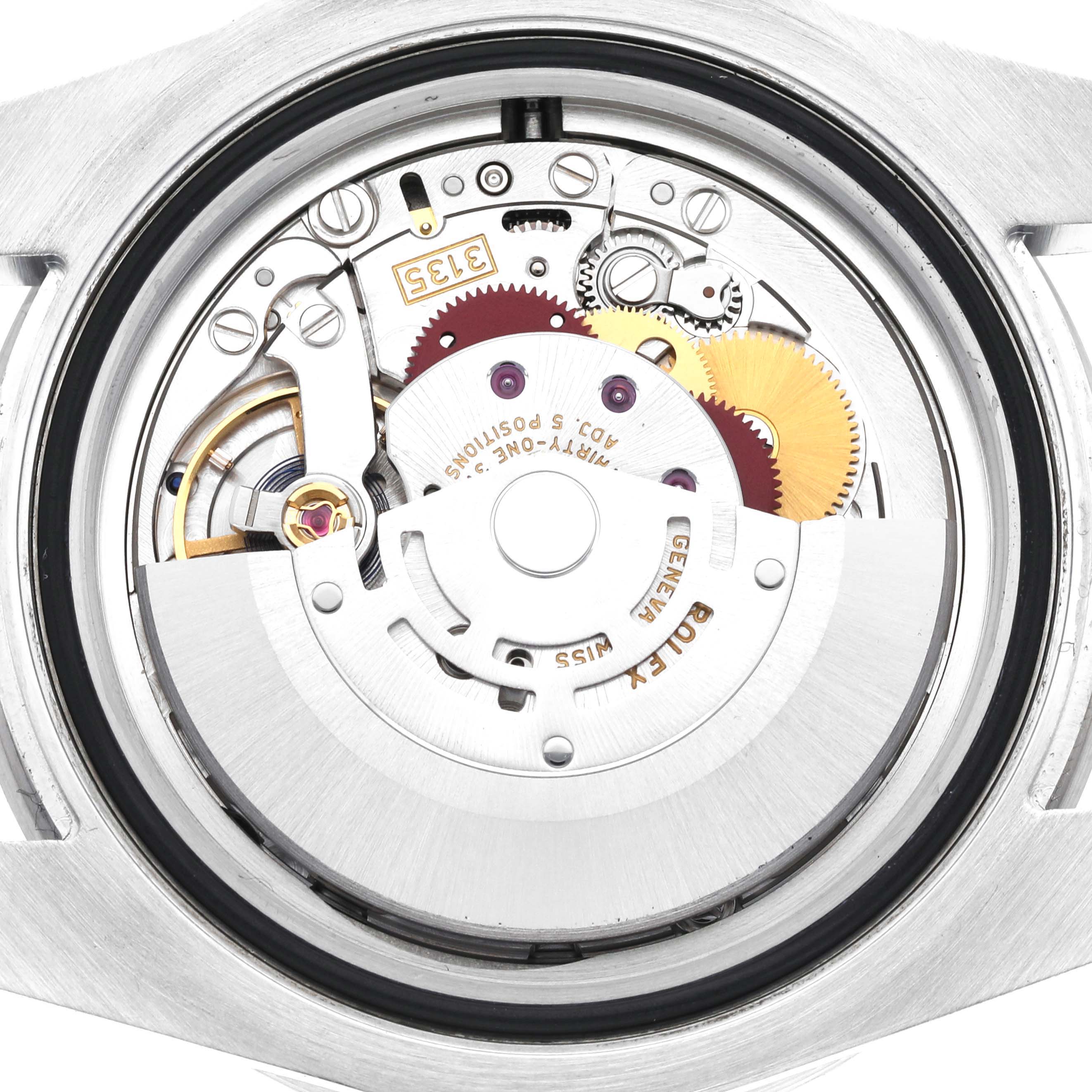 The image shows the back view of the Rolex Submariner 116610LV Men
s Stainless Steel Green Dial 116610LV Men
s Stainless Steel Green Dial watch, focusing on its intricate internal movement components.