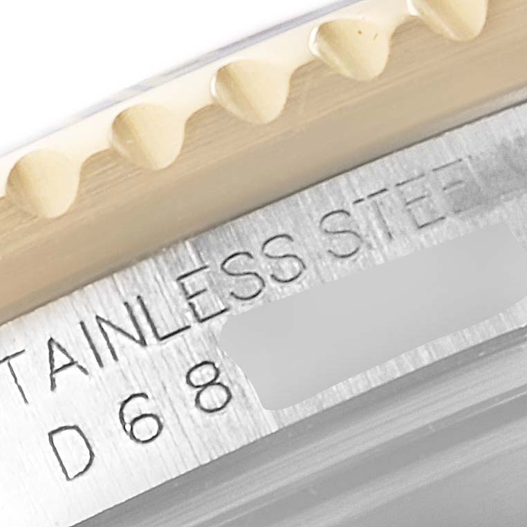 This close-up image shows the engraving on the side of the stainless steel case of a Rolex Submariner 16613 Men
s Steel and Gold (two tone) Grey Dial 16613 Men
s Steel and Gold (two tone) Grey Dial watch.