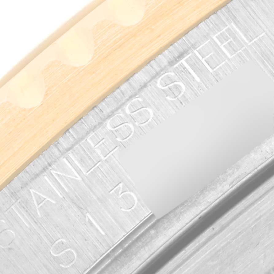 This image shows a close-up of the engraving on the case back of a Rolex Submariner 16613 Men's Steel and Gold (two tone) Black Dial 16613 Men's Steel and Gold (two tone) Black Dial, highlighting the "STAINLESS STEEL" marking.