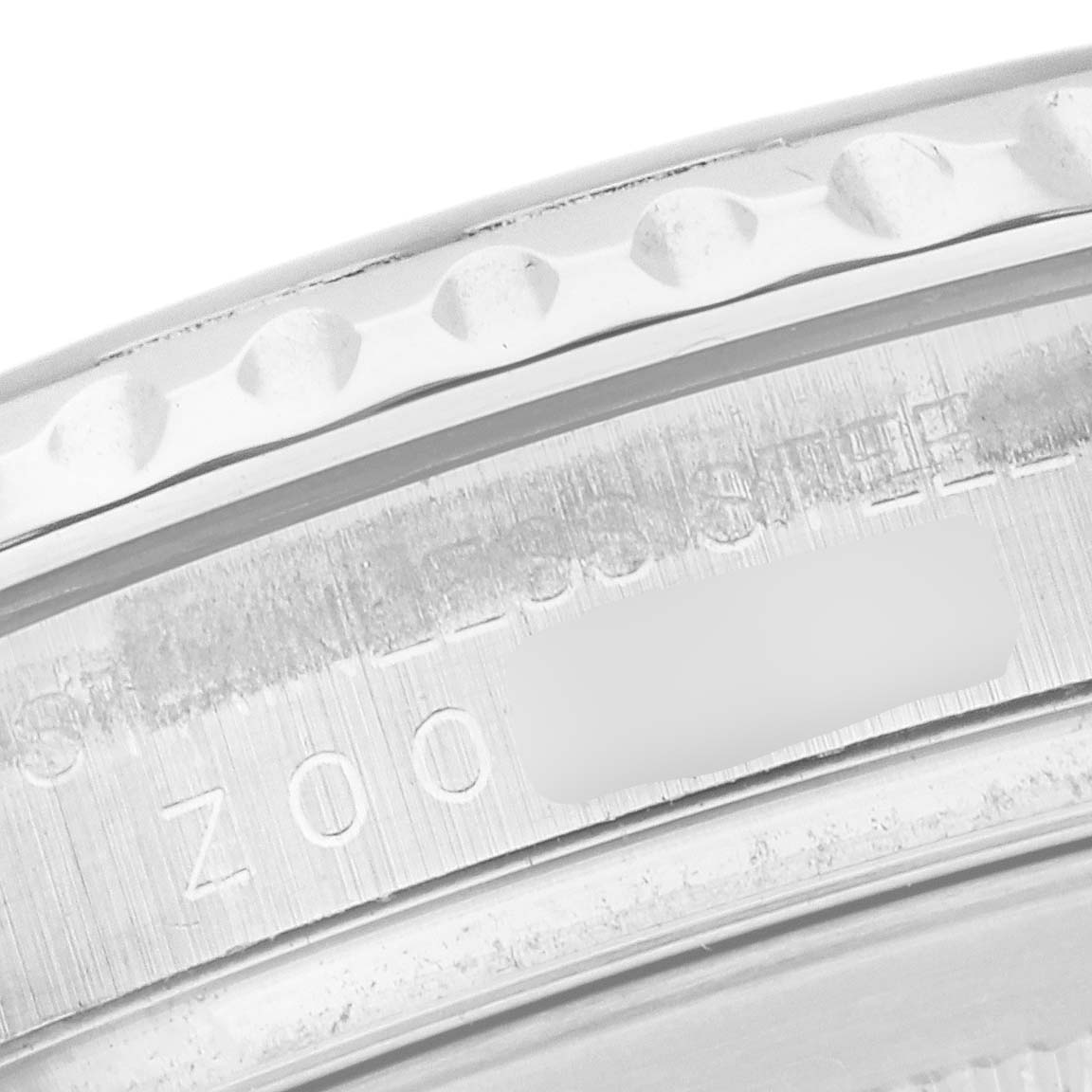 The image shows a close-up of the bezel and part of the case back of a Rolex Yacht-Master 16622 Men's Stainless Steel Silver Dial 16622 Men's Stainless Steel Silver Dial watch, highlighting the stainless steel text.