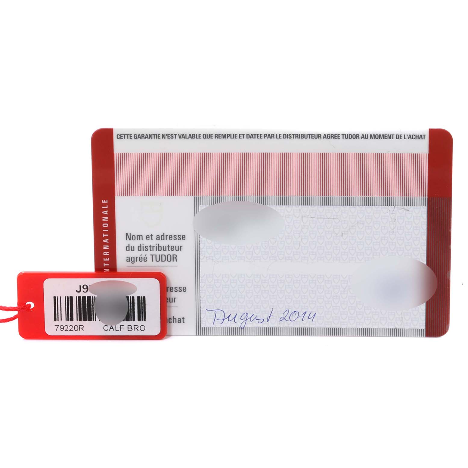 This image shows the warranty card and tag for the Tudor Heritage Black Bay 79220R Men
s Stainless Steel Black Dial 79220R Men
s Stainless Steel Black Dial model, including the model number 79220R.