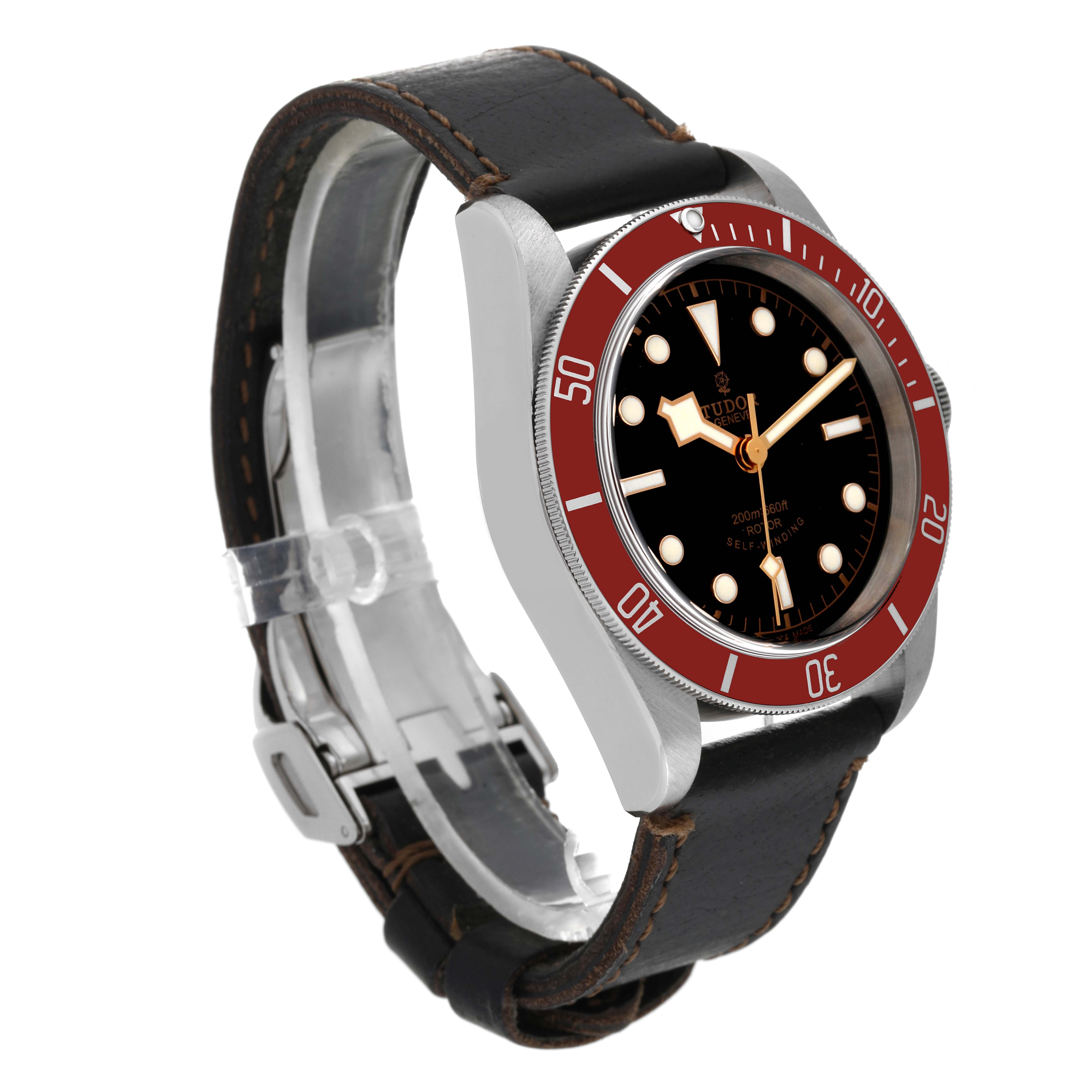The image shows a side and front view of the Tudor Heritage Black Bay 79220R Men
s Stainless Steel Black Dial 79220R Men
s Stainless Steel Black Dial watch, featuring a black dial, red bezel, and leather strap.