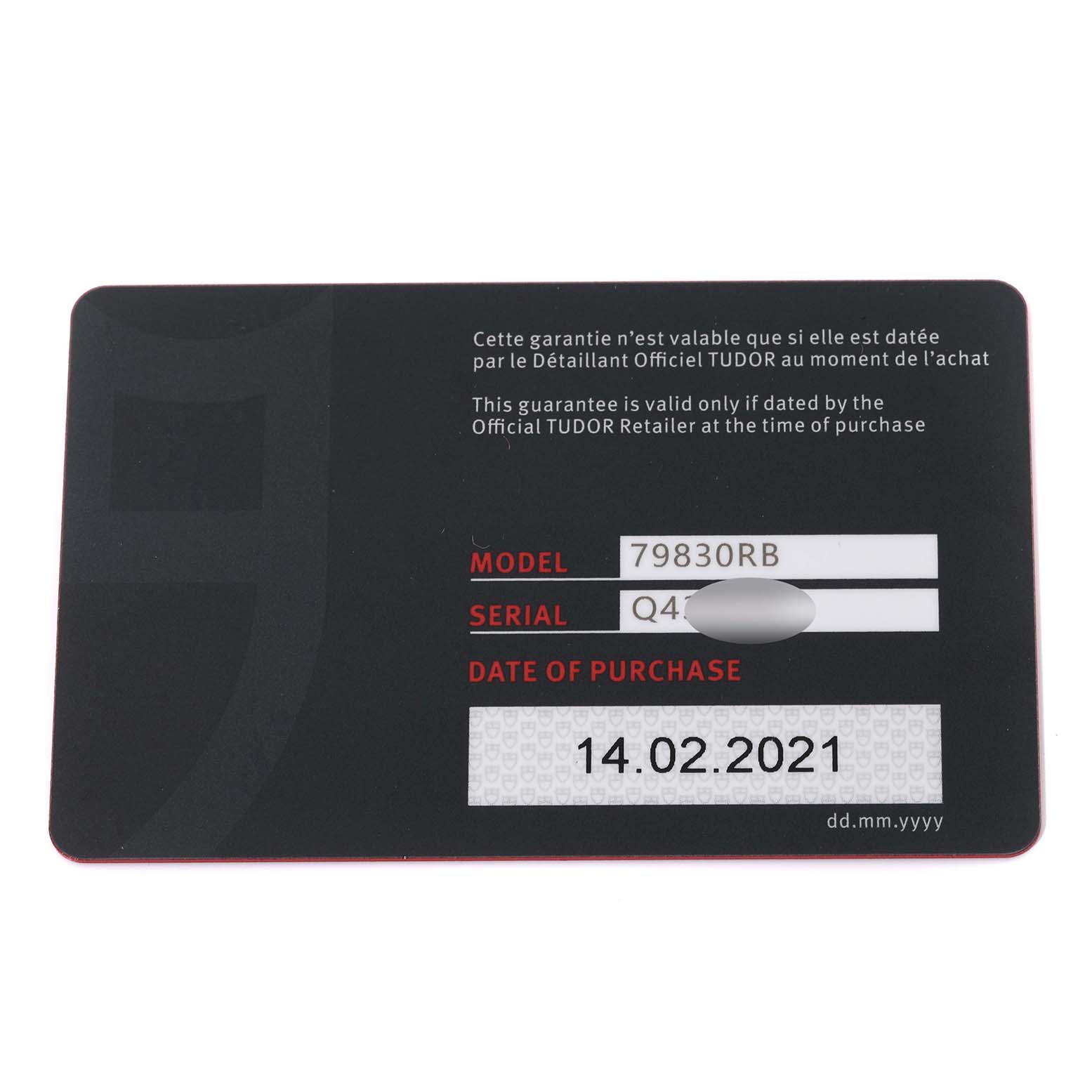 The image shows a warranty card for the Tudor Heritage Black Bay 79830RB Men
s Stainless Steel Black Dial 79830RB Men
s Stainless Steel Black Dial model in a top-down view.