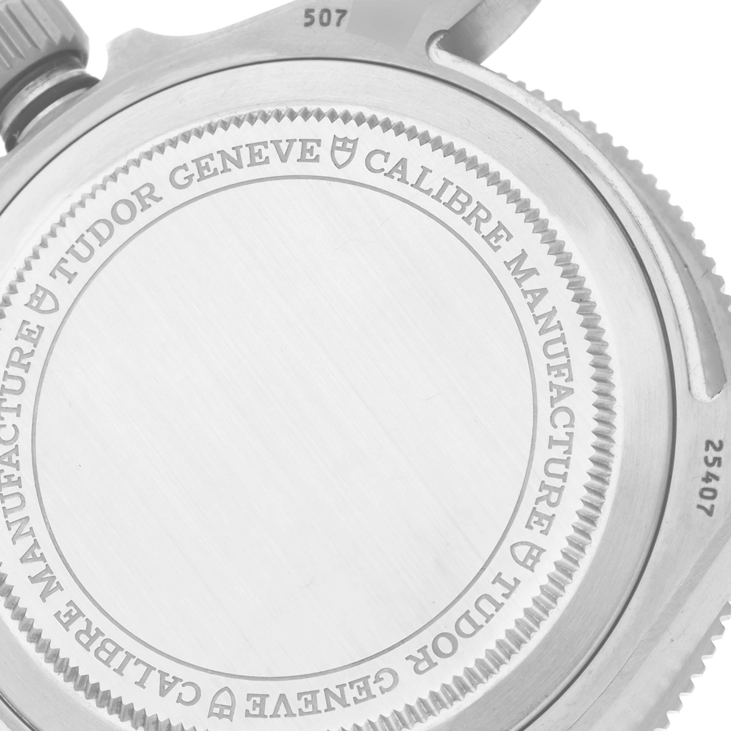 The image shows the back case of a Tudor Pelagos 25407N Men
s Titanium Black Dial 25407N Men
s Titanium Black Dial watch, highlighting the engraving and part of the crown.