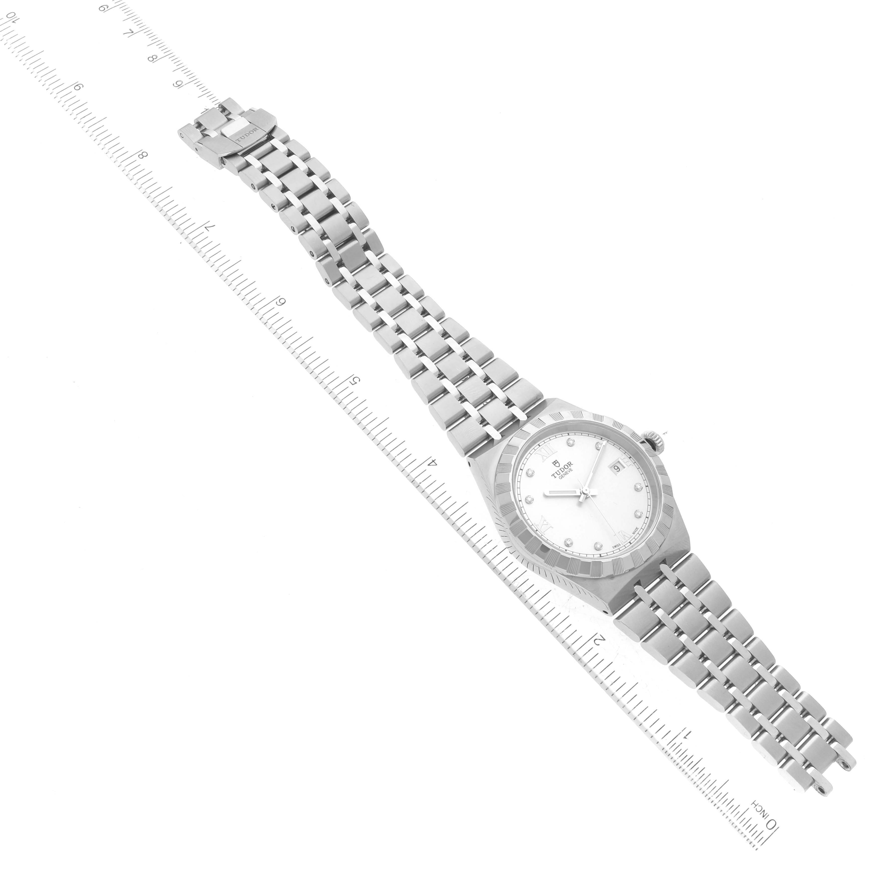 The Tudor Royal 28500 Men
s Stainless Steel Silver Dial 28500 Men
s Stainless Steel Silver Dial watch is shown lying flat with the entire bracelet and face visible, positioned next to a ruler for scale.