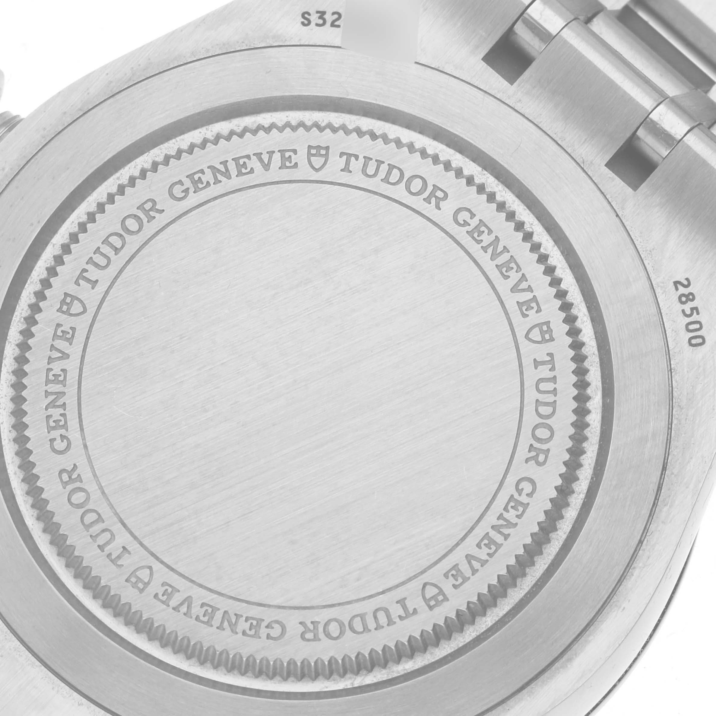 The image shows the case back of a Tudor Royal 28500 Men
s Stainless Steel Silver Dial 28500 Men
s Stainless Steel Silver Dial watch, displaying the brand name and some bracelet links.