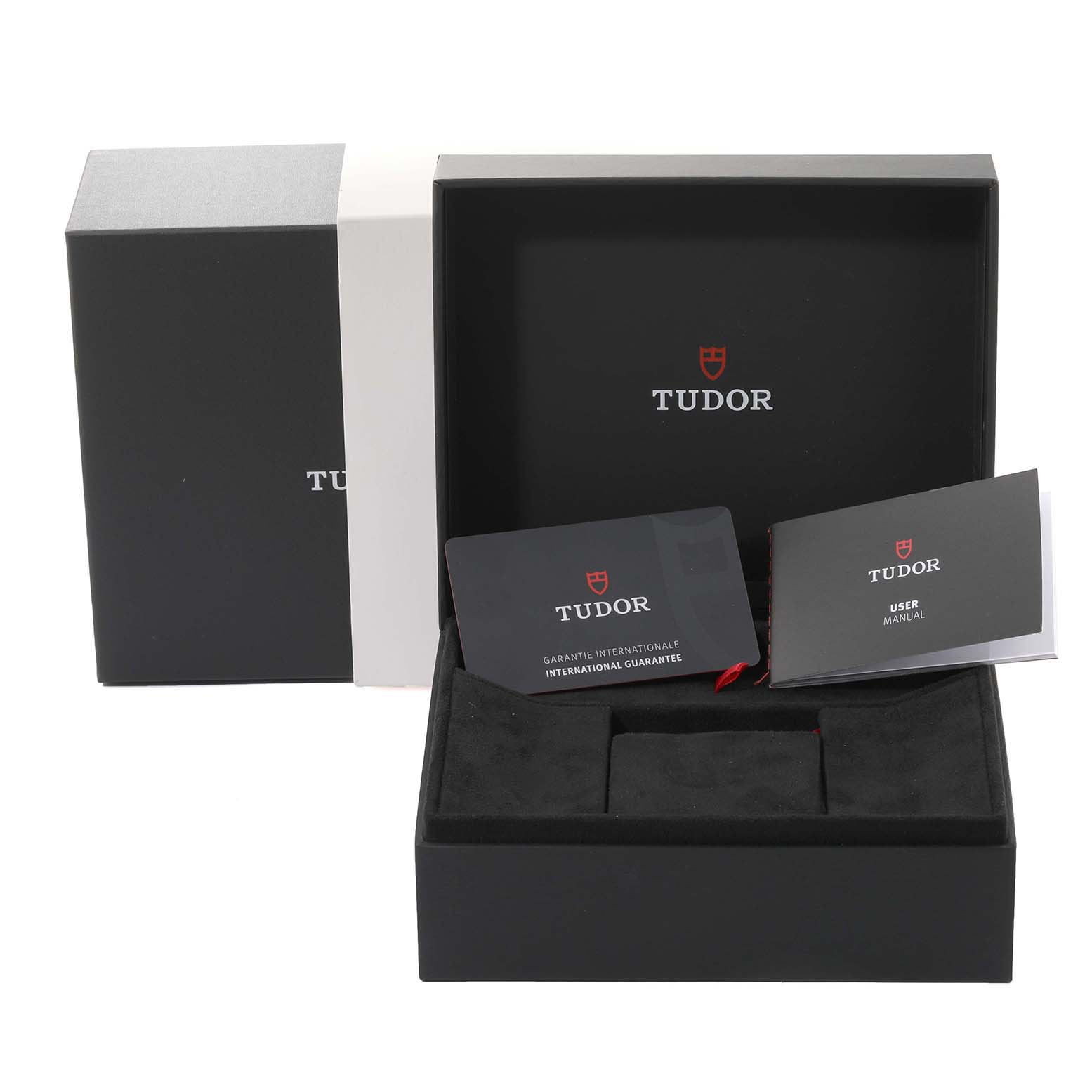 The image shows a Tudor Royal 28500 Men
s Stainless Steel Silver Dial 28500 Men
s Stainless Steel Silver Dial watch box, user manual, and international guarantee card, viewed from a front angle.