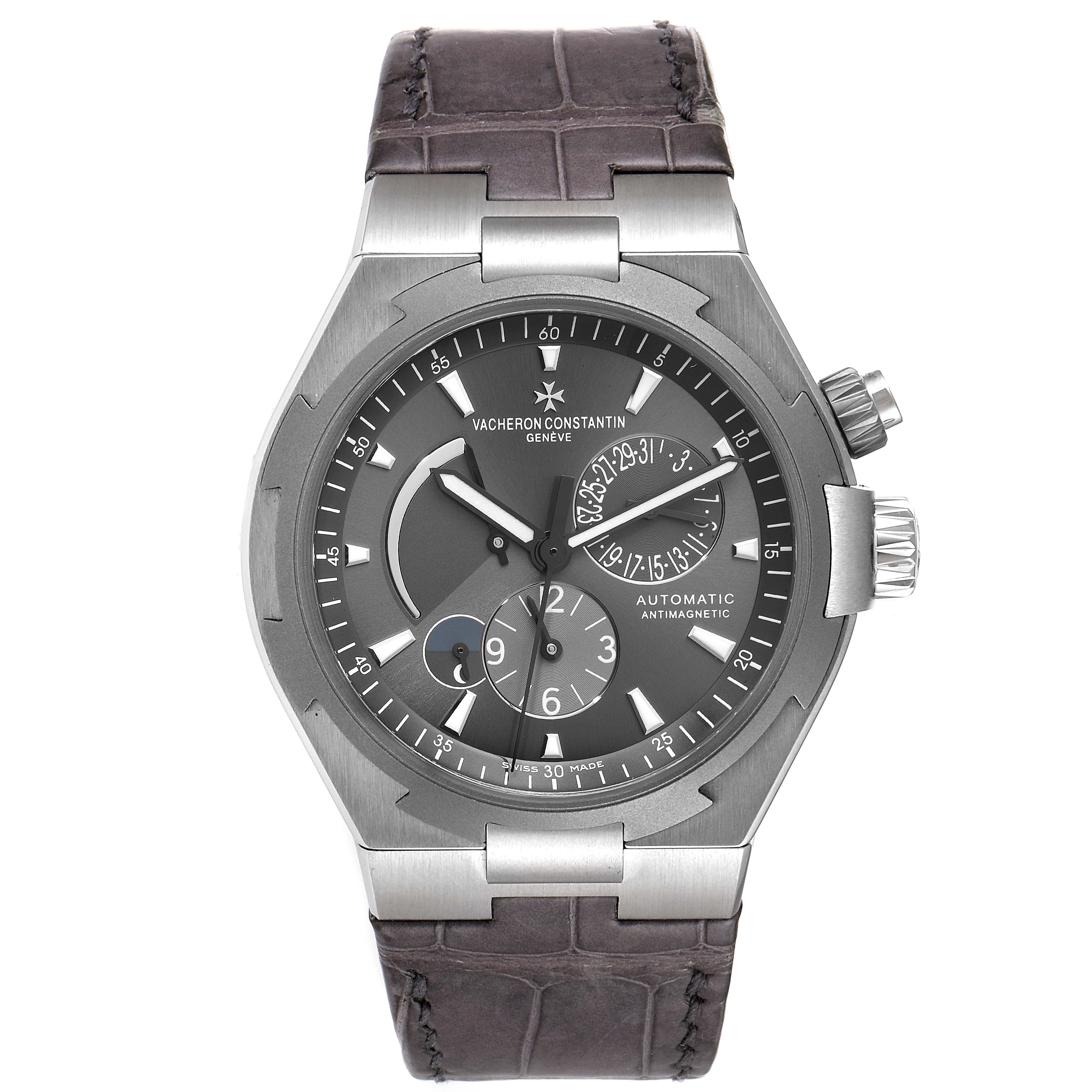 The image shows a Vacheron Constantin Overseas 47450/000W-9511 Men's Stainless Steel Grey Dial 47450/000W-9511 Men's Stainless Steel Grey Dial model watch from a front angle, displaying its face, bezel, and strap.
