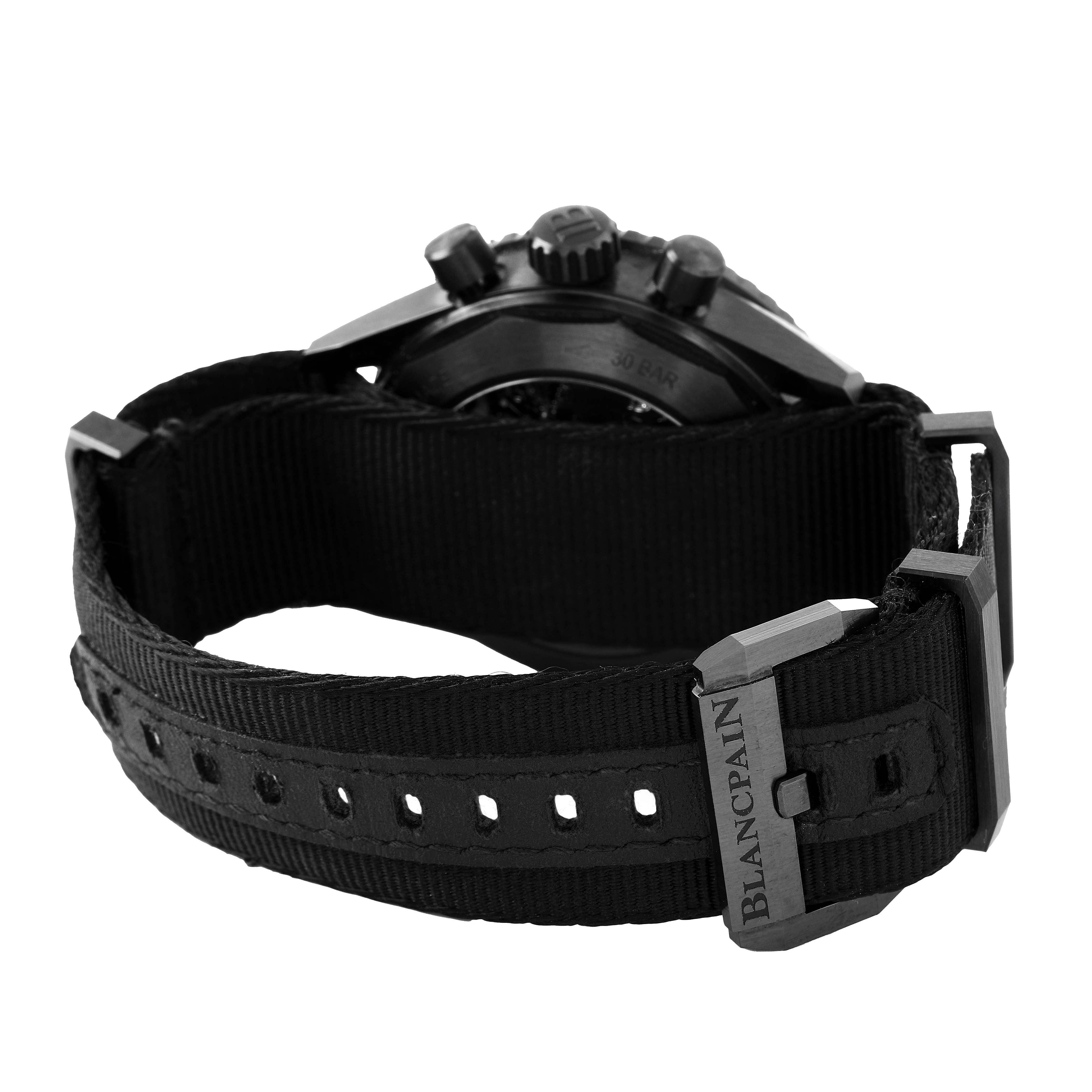 The image shows the Blancpain Fifty Fathoms 5200-0130-NABA Men's Ceramic Black Dial watch from a rear angle, focusing on the strap and buckle.