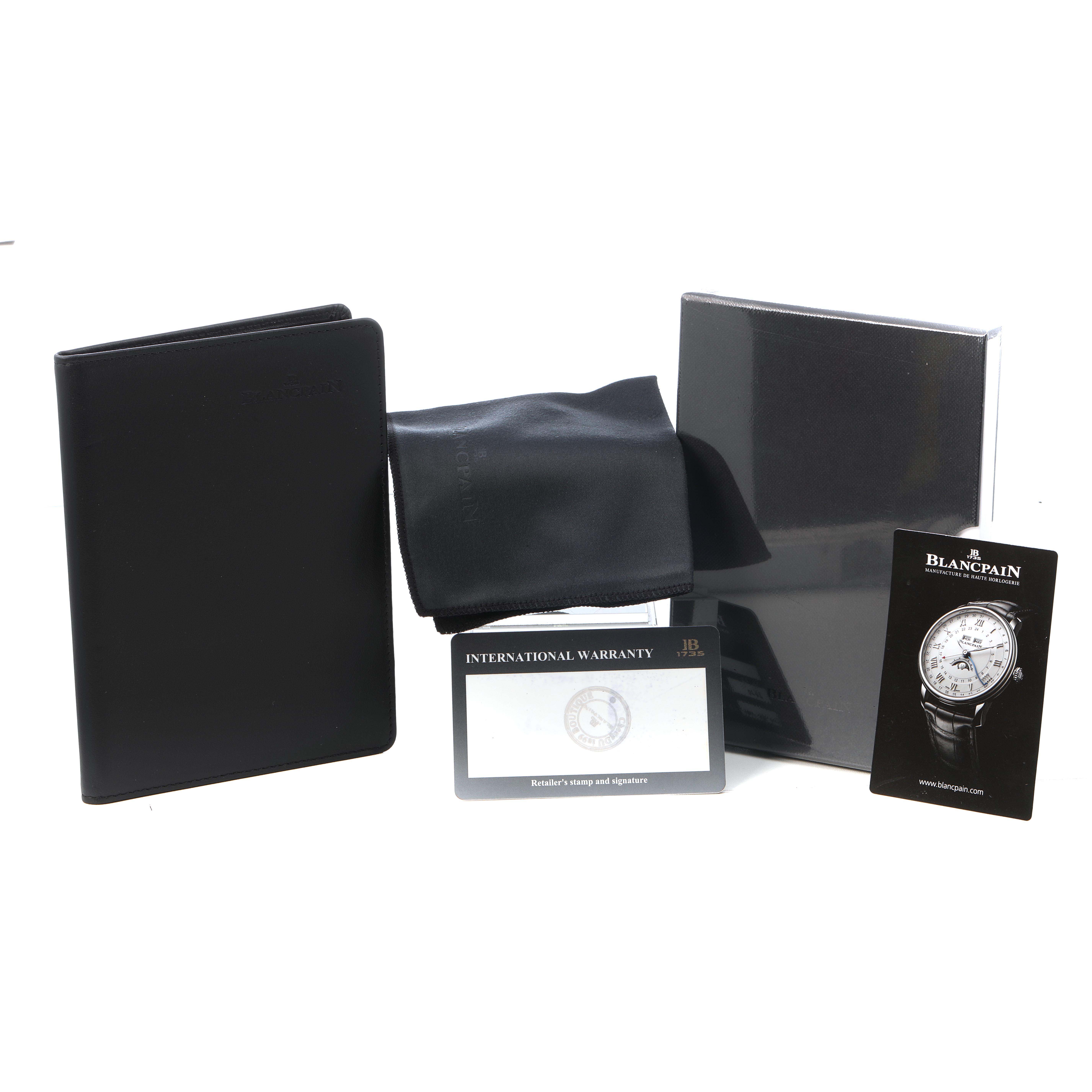 The image shows Blancpain Fifty Fathoms 5200-0130-NABA Men's Ceramic Black Dial accessories including a booklet, cleaning cloth, warranty card, and a promotional card, angled frontally.