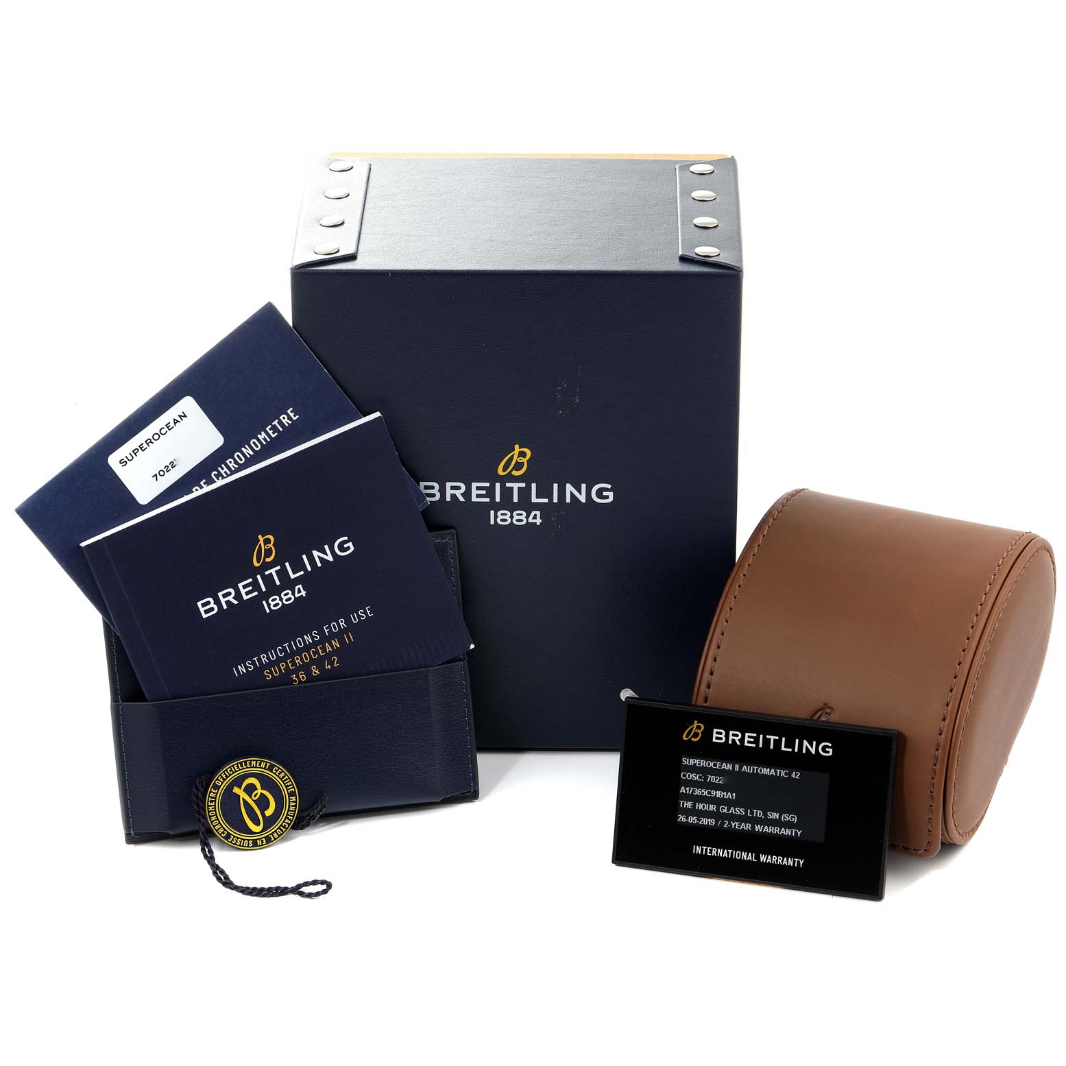 The image shows accessories for the Breitling Superocean A17365 Men's Stainless Steel Black Dial A17365 Men's Stainless Steel Black Dial model, including a box, instructions, warranty card, and a leather case.