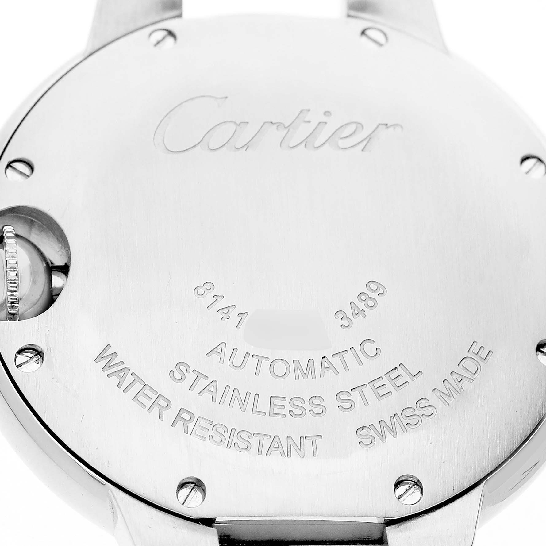 The image shows the back casing of the Ballon Bleu by Cartier watch, featuring engraved details and the crown on the side.