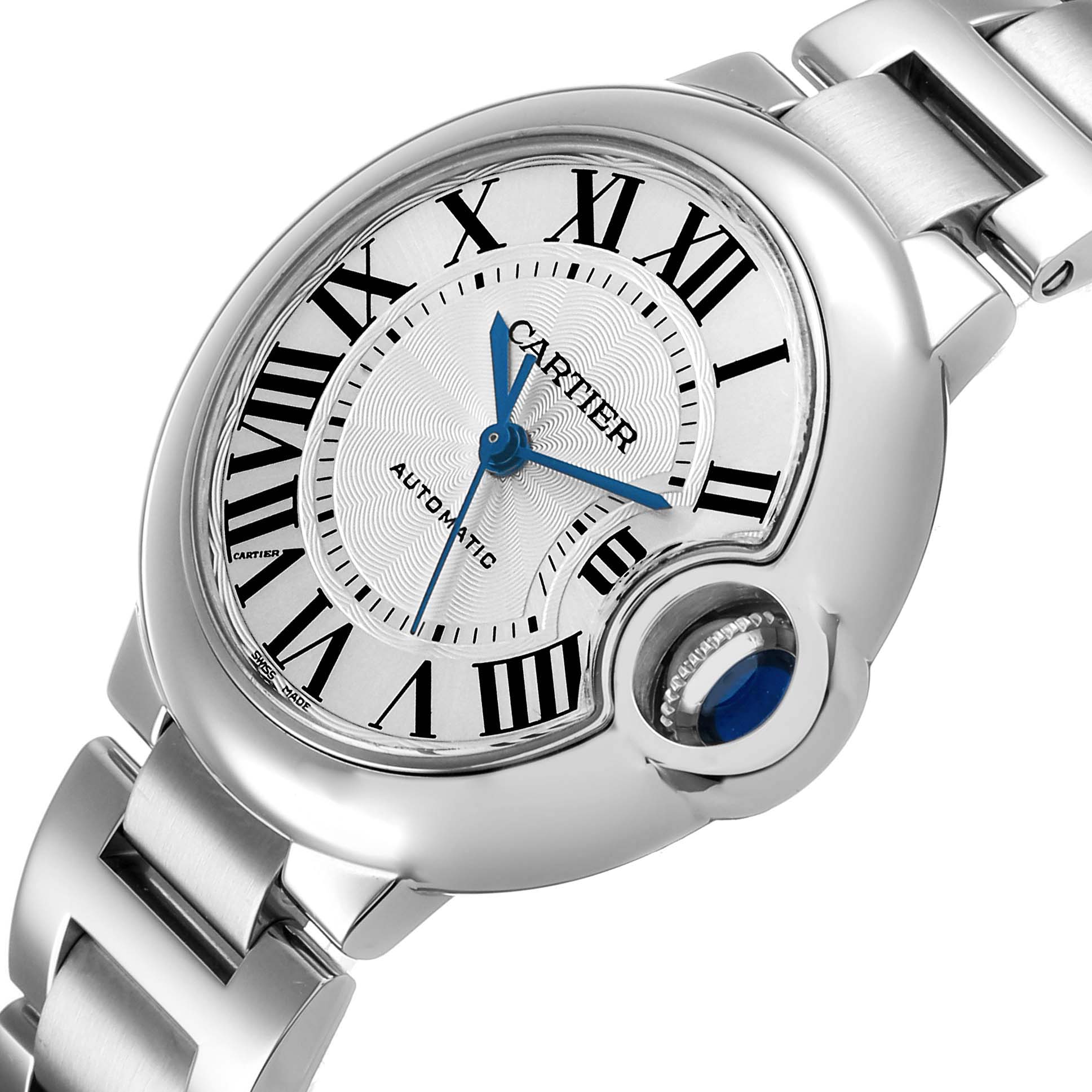 The image shows a Cartier Ballon Bleu W6920071 Women's Stainless Steel Silver Dial watch at an angle highlighting the dial, Roman numerals, blue hands, and the crown with a blue cabochon.