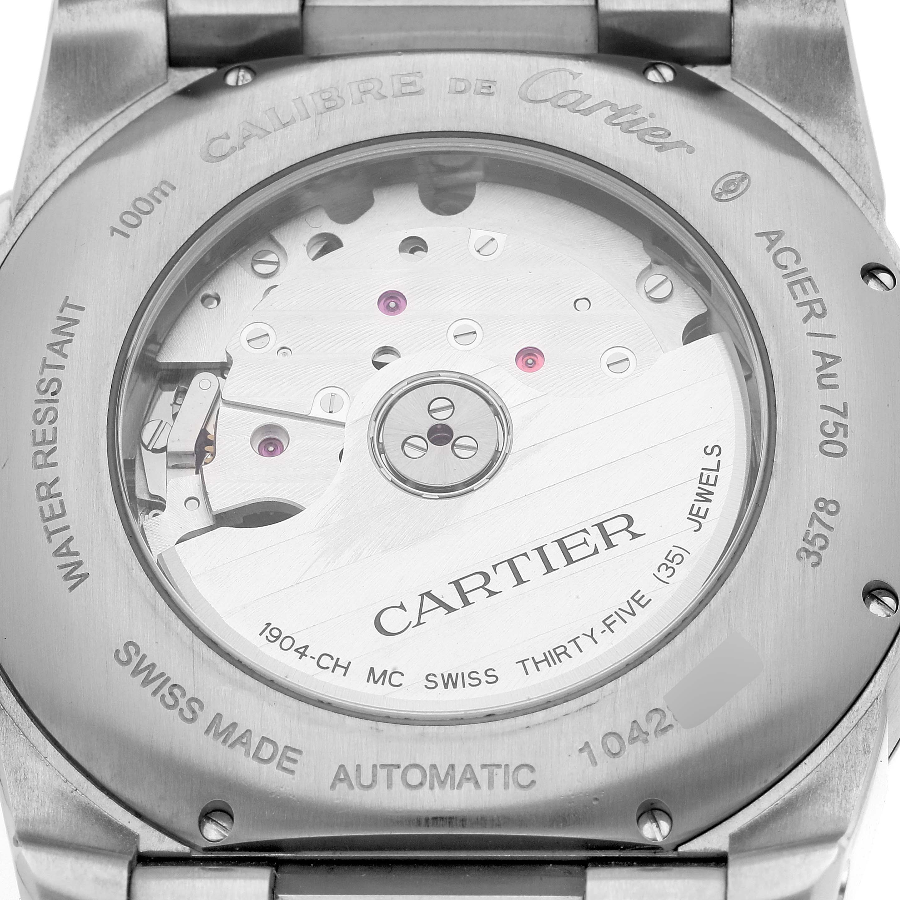 The image shows the back case of a Calibre de Cartier watch, displaying the automatic movement and inner mechanism.