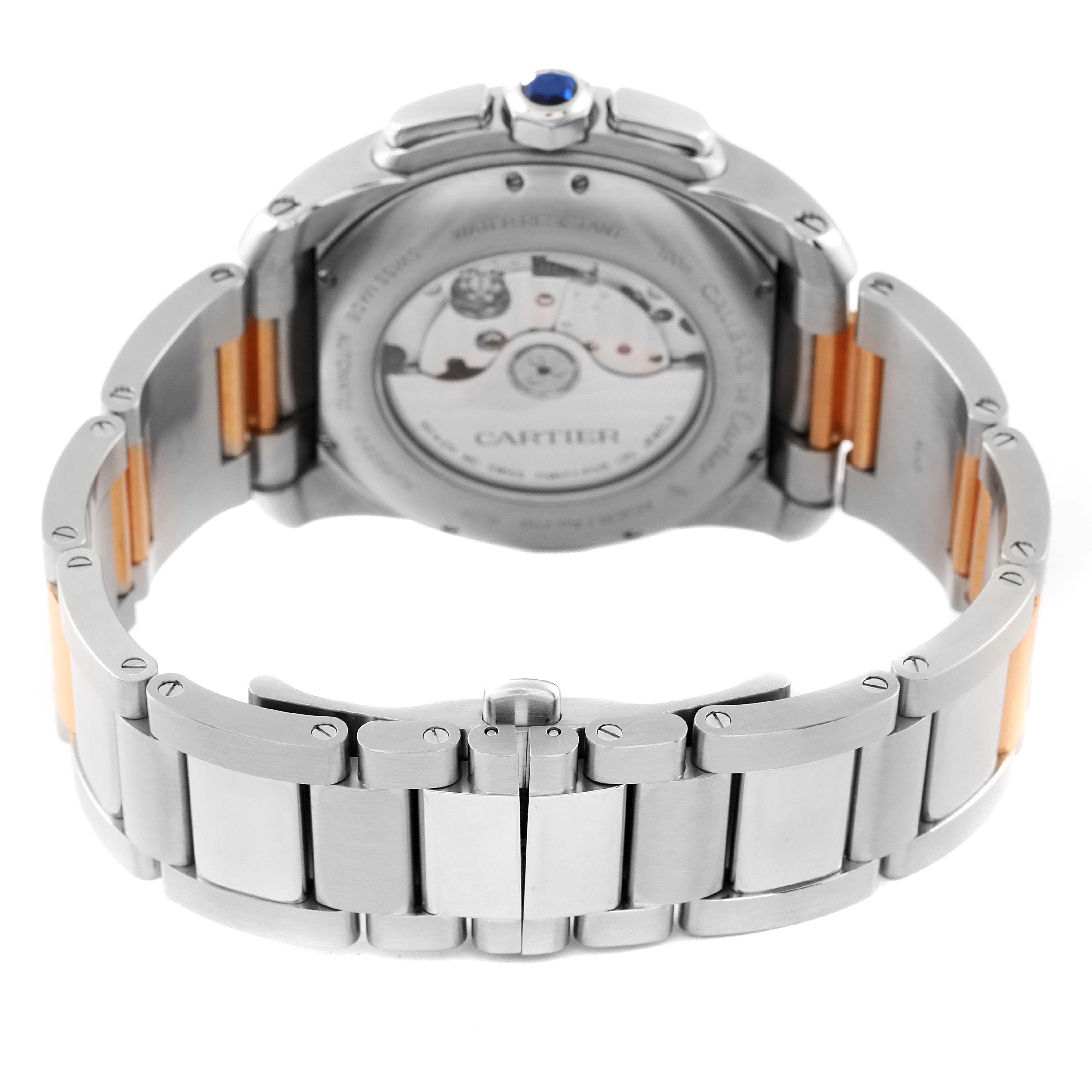 The image shows the back and bracelet of a Calibre de Cartier watch by Cartier, highlighting the movement and clasp.