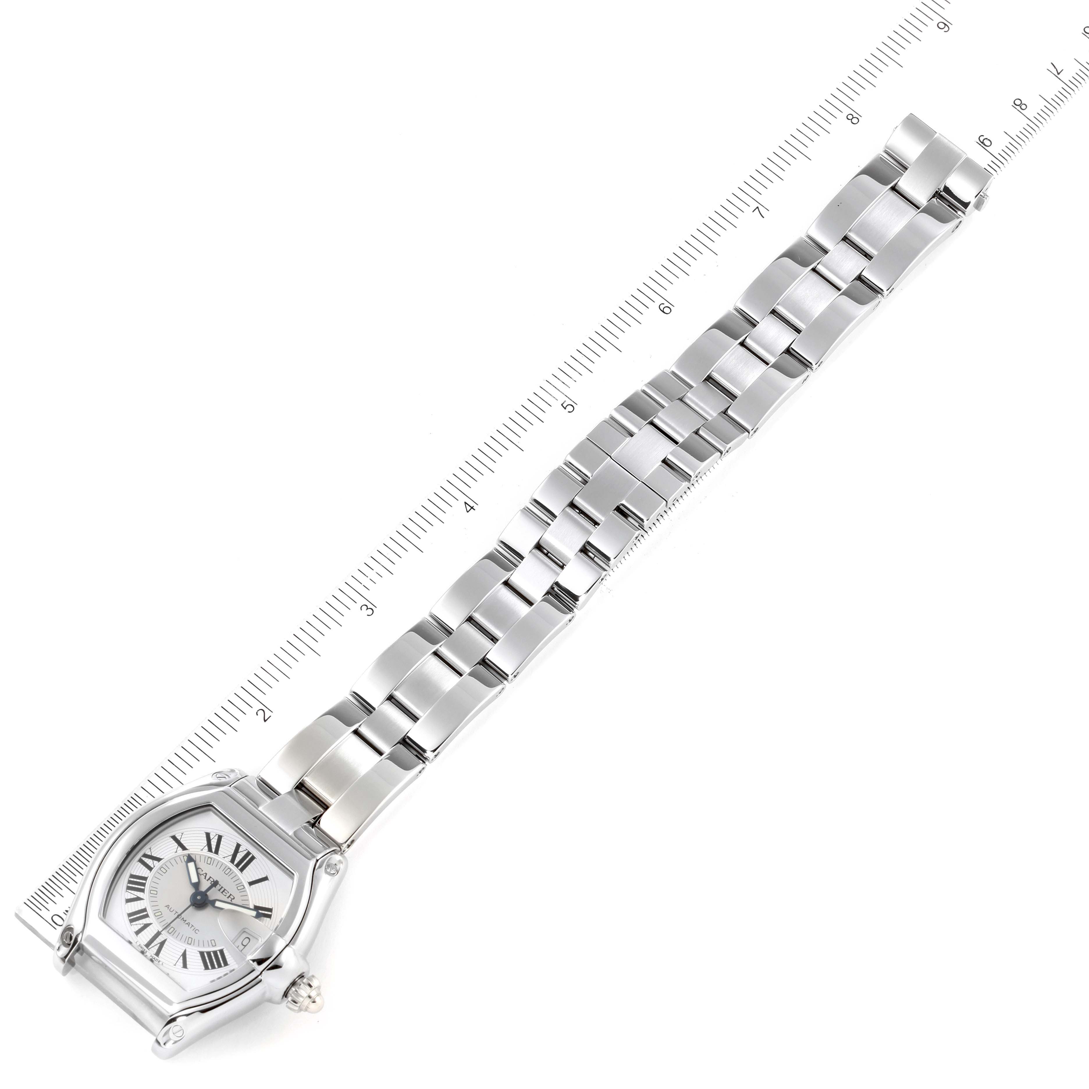 The image shows the face and bracelet of a Cartier Roadster W62000V3 Men
s Stainless Steel Silver Dial W62000V3 Men
s Stainless Steel Silver Dial watch, laid flat with a ruler next to it.