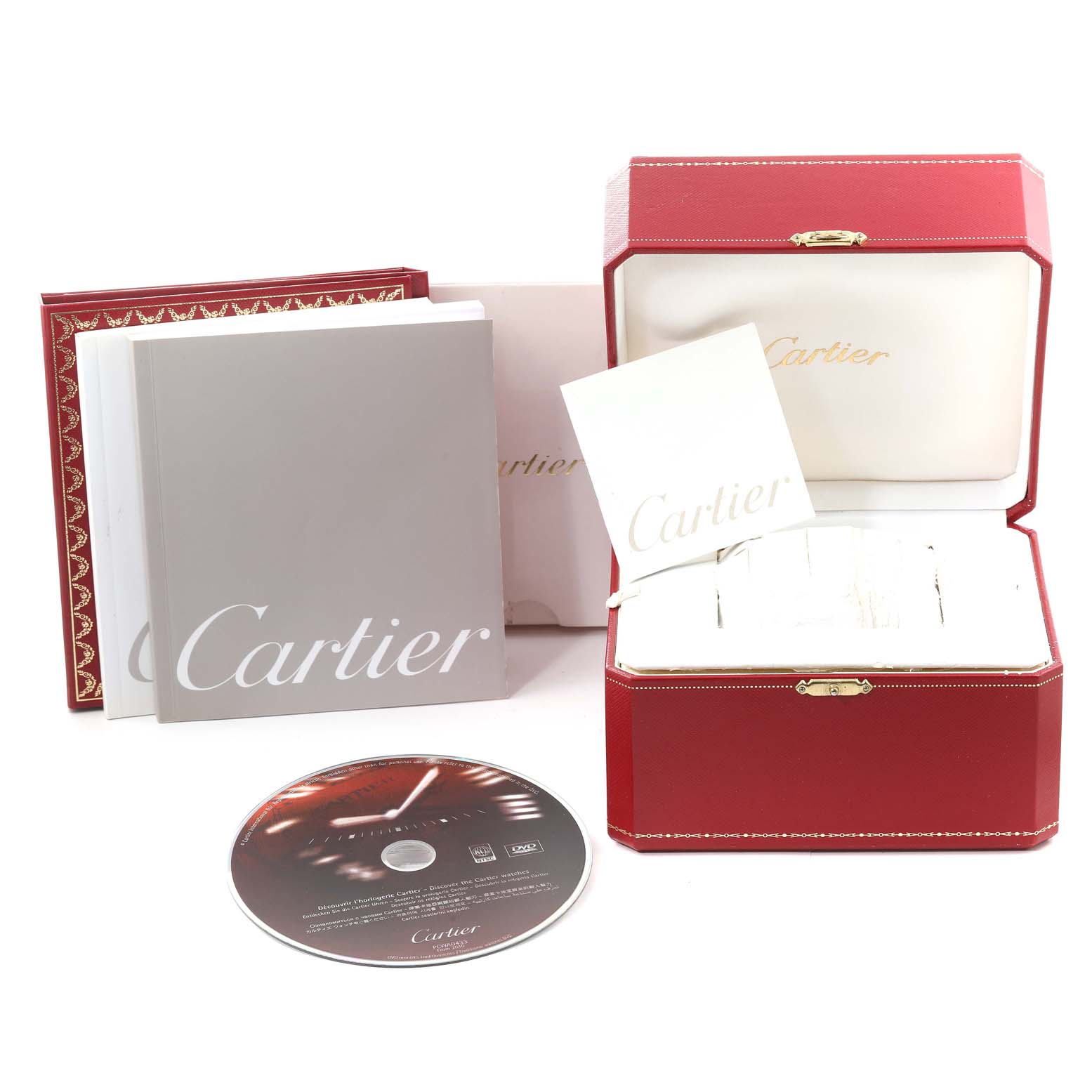 The image shows the Cartier Roadster W62020X6 Men's Stainless Steel Black Dial W62020X6 Men's Stainless Steel Black Dial watch box, manual, warranty card, and a DVD, all arranged neatly.
