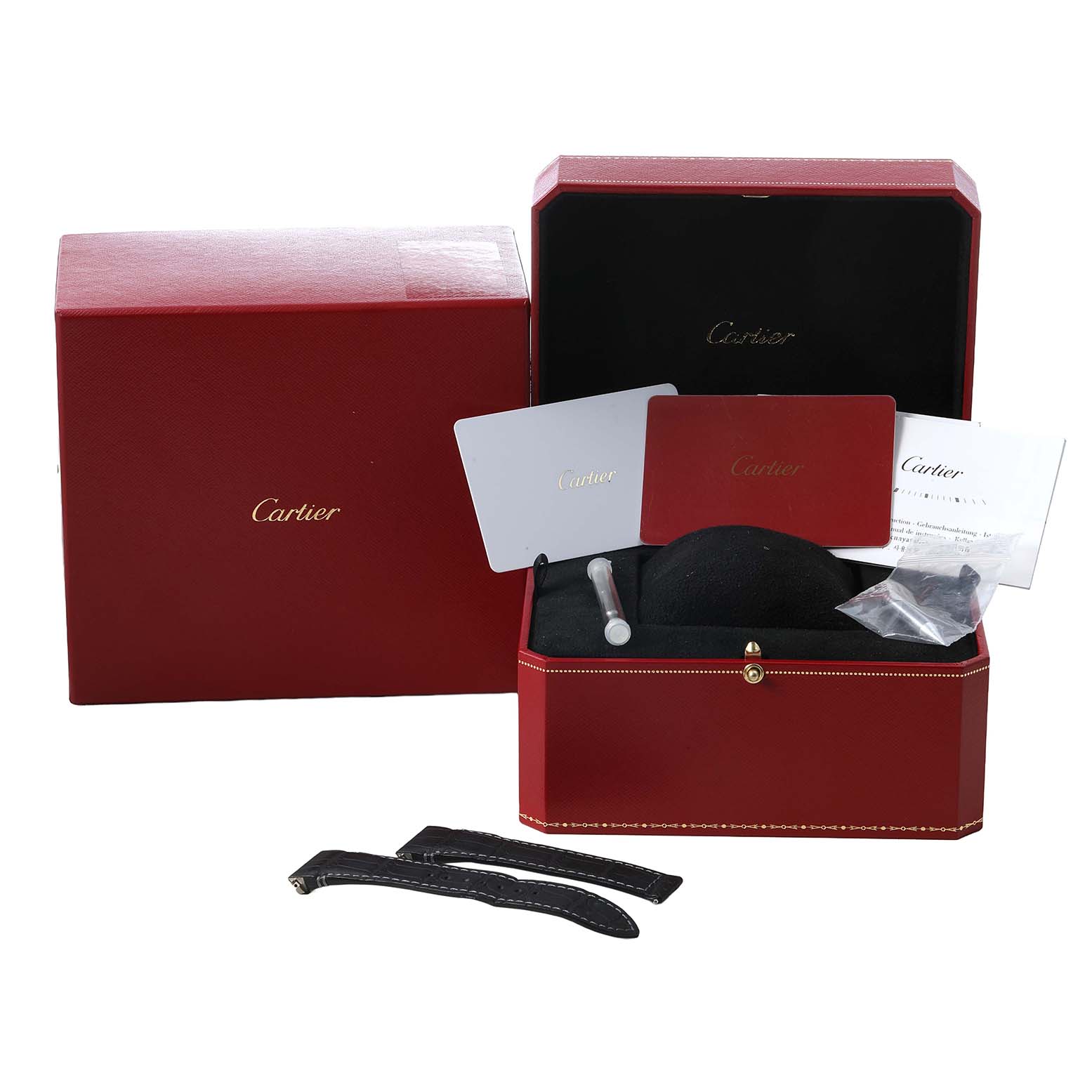 The image shows a Cartier Santos WSSA0017 Men's Stainless Steel Silver Dial watch box, additional straps, documentation, and accessories from a frontal angle.